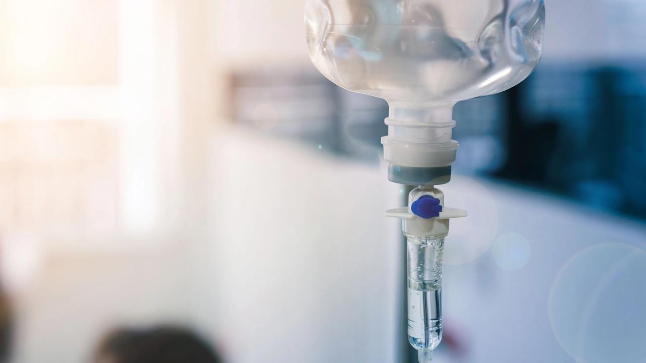 Healthcare concept, Close up of medical drip or IV drip chamber in patient room, Selective focus.