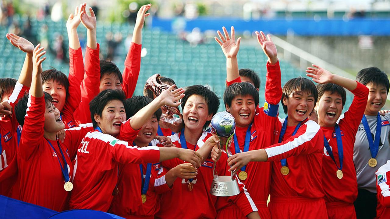 AUCKLAND, NEW ZEALAND - NOVEMBER 16:  North Korea celebrate with the trophy after winning the FIFA U17 Women's World Cup Final match between the USA and North Korea at North Harbour Stadium on November 16, 2008 in Auckland, New Zealand.  (Photo by Sandra Mu/Getty Images)