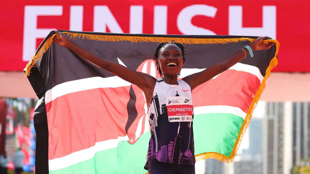 CHICAGO, ILLINOIS - OCTOBER 13: Ruth Chepngetich of Kenya celebrates after crossing the finish line to win the 2024 Chicago Marathon professional women's division and setting a new world record with a time of 2:09:56 at Grant Park on October 13, 2024 in Chicago, Illinois. (Photo by Michael Reaves/Getty Images)