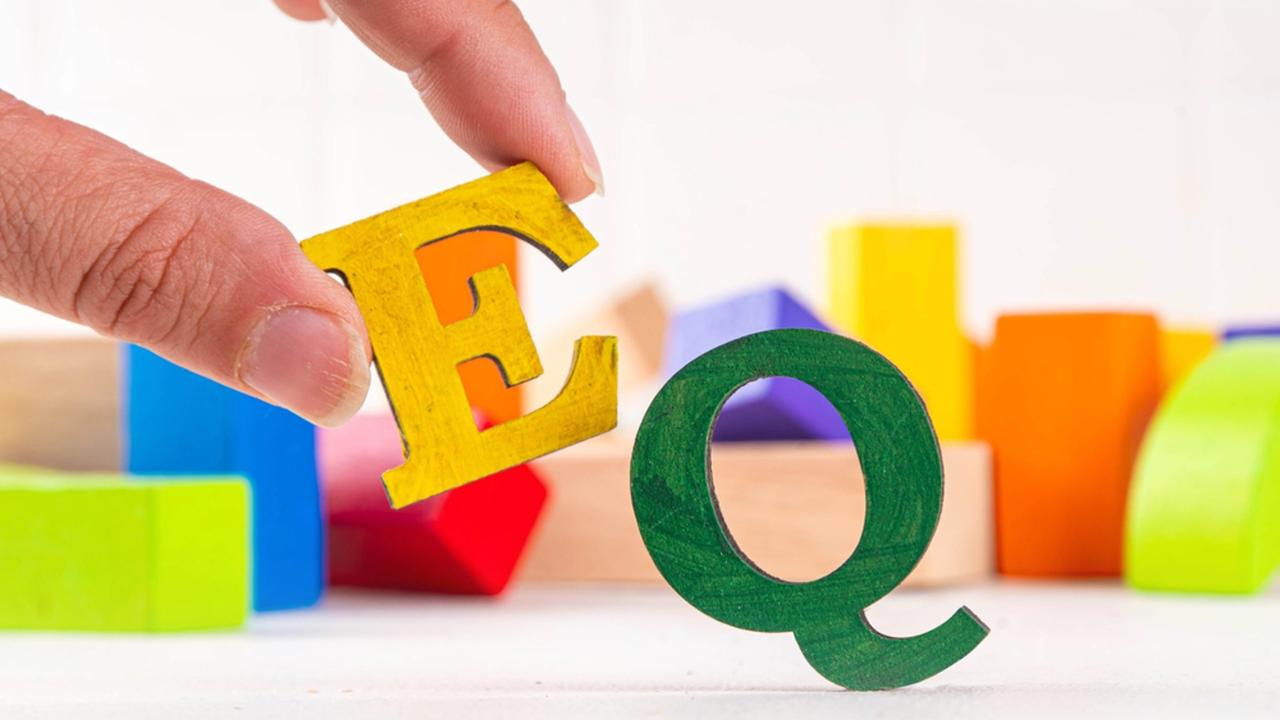Kids EQ, child emotional quotient concept with wooden cubes children toys on background, wooden cubes kids toys on background, letters text lettering EQ in the foreground