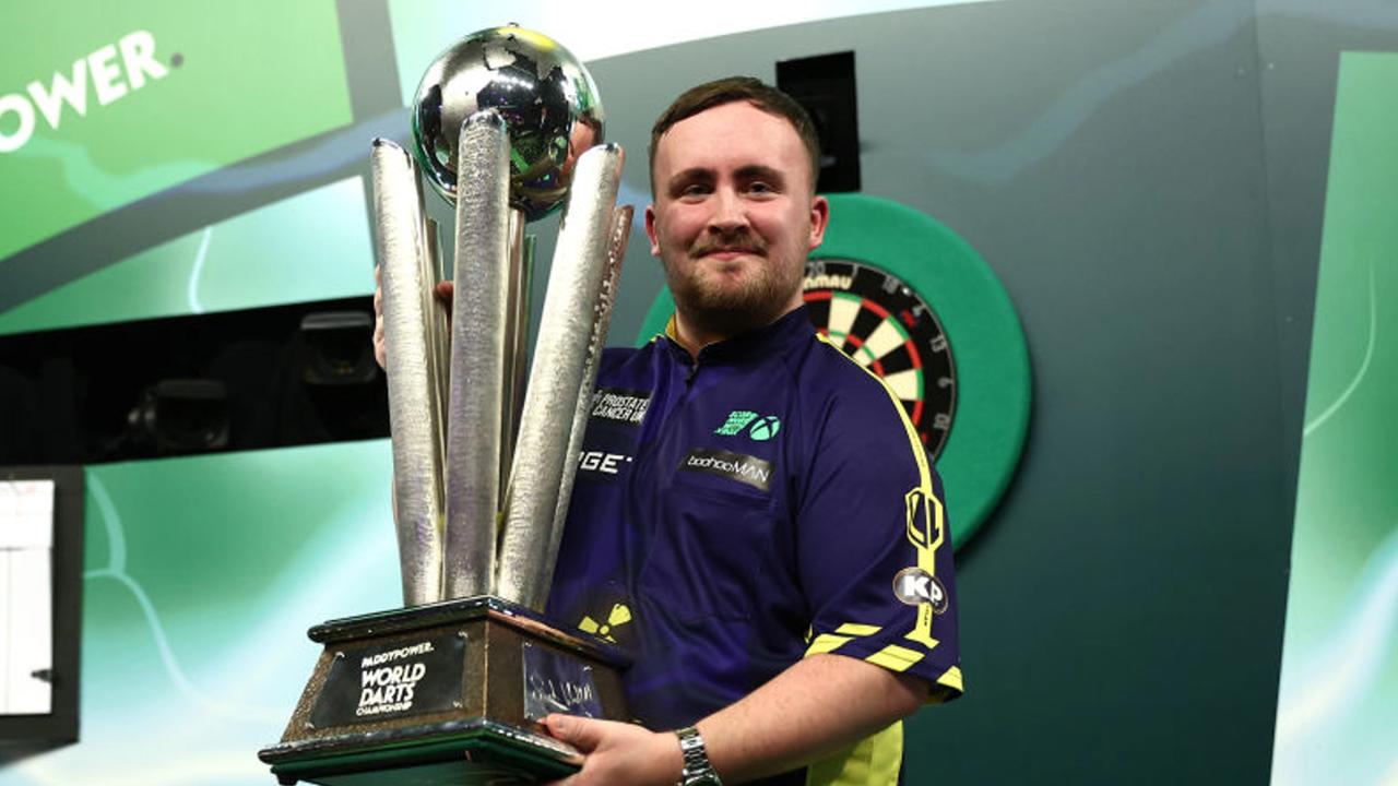 LONDON, ENGLAND - JANUARY 03: Luke Littler of England lifts the trophy as he celebrates winning the Final against Michael van Gerwen of The Netherlands during day sixteen of the 2024/25 Paddy Power World Darts Championship at Alexandra Palace on January 03, 2025 in London, England. (Photo by James Fearn/Getty Images)