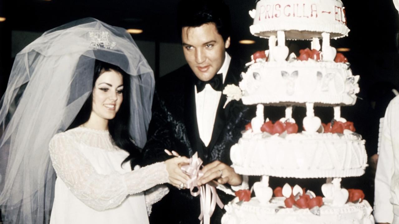 (Original Caption) Las Vegas, Nevada, Entertainer, Elvis Presley cuts wedding cake with his bride, the former Priscilla Ann Beaulieu, May 1, 1967.