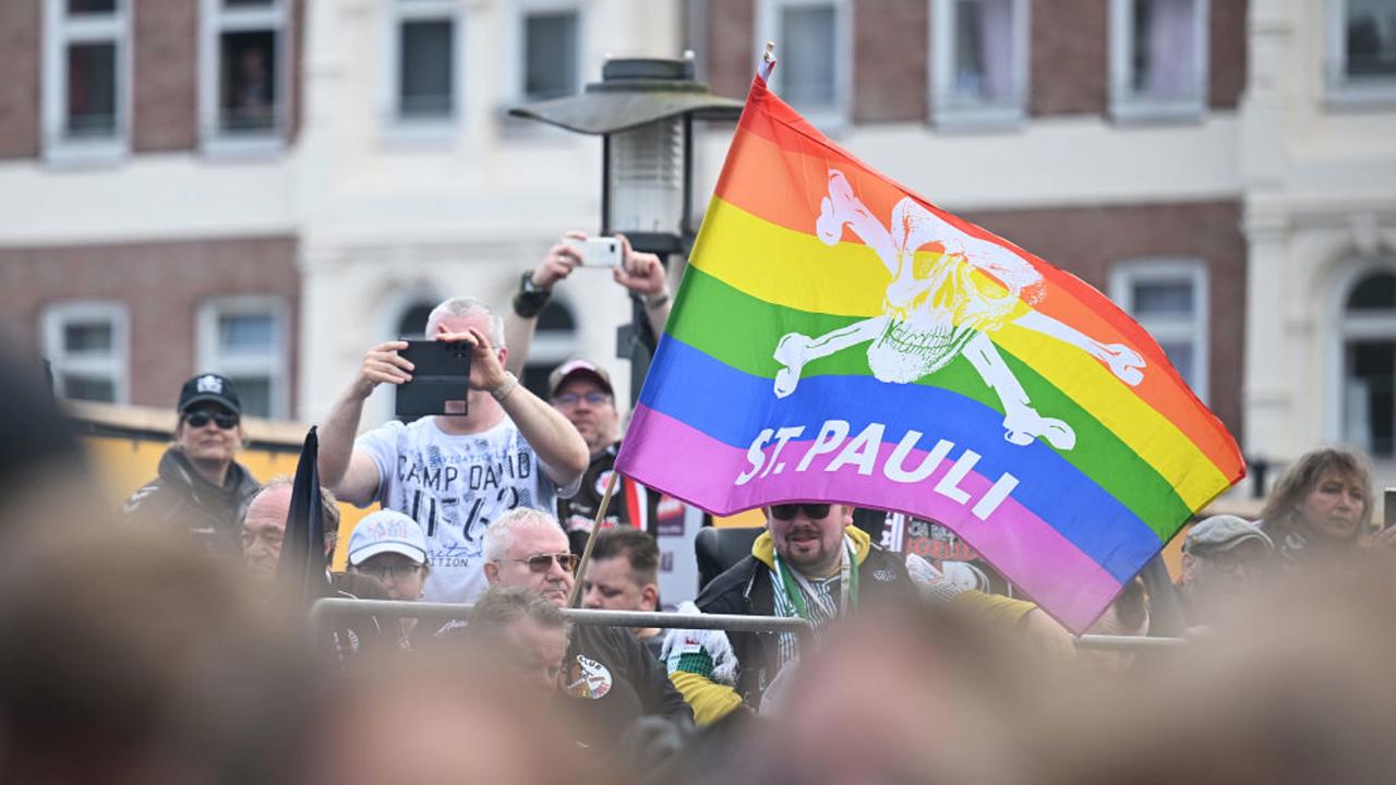 HAMBURG, GERMANY - MAY 20: Fans of FC St. Pauli display a rainbow coloured FC St. Pauli flag during the St. Pauli Championship Party on May 20, 2024 in Hamburg, Germany. (Photo by Stuart Franklin/Getty Images)