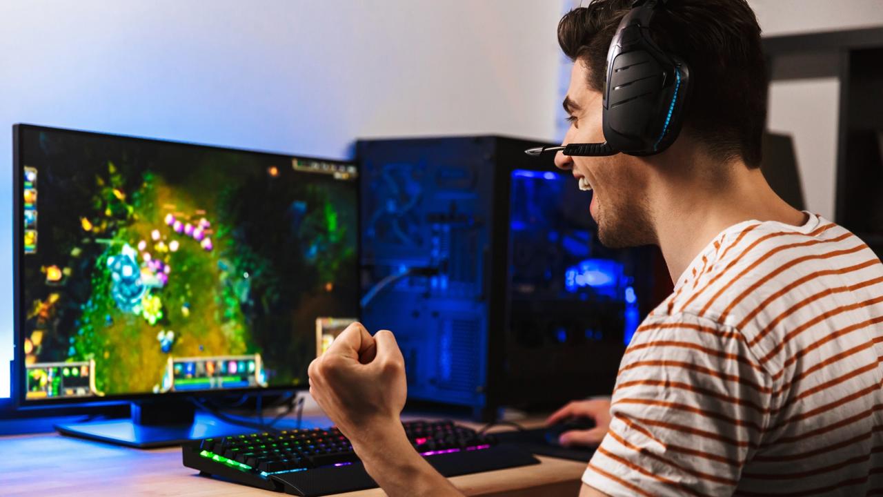 Portrait,Of,Delighted,Young,Guy,Playing,Video,Games,On,Computer