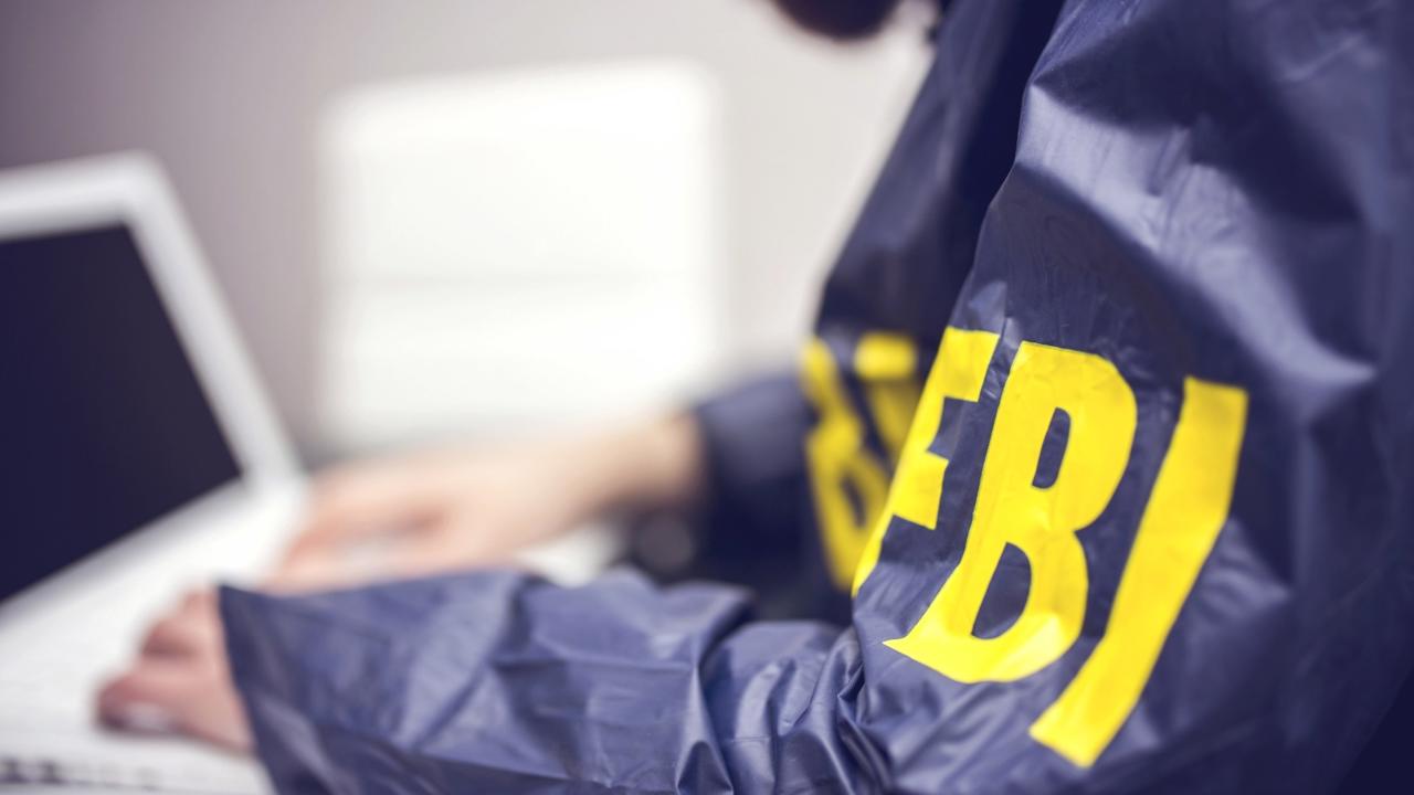 FBI agent working on his computer in office