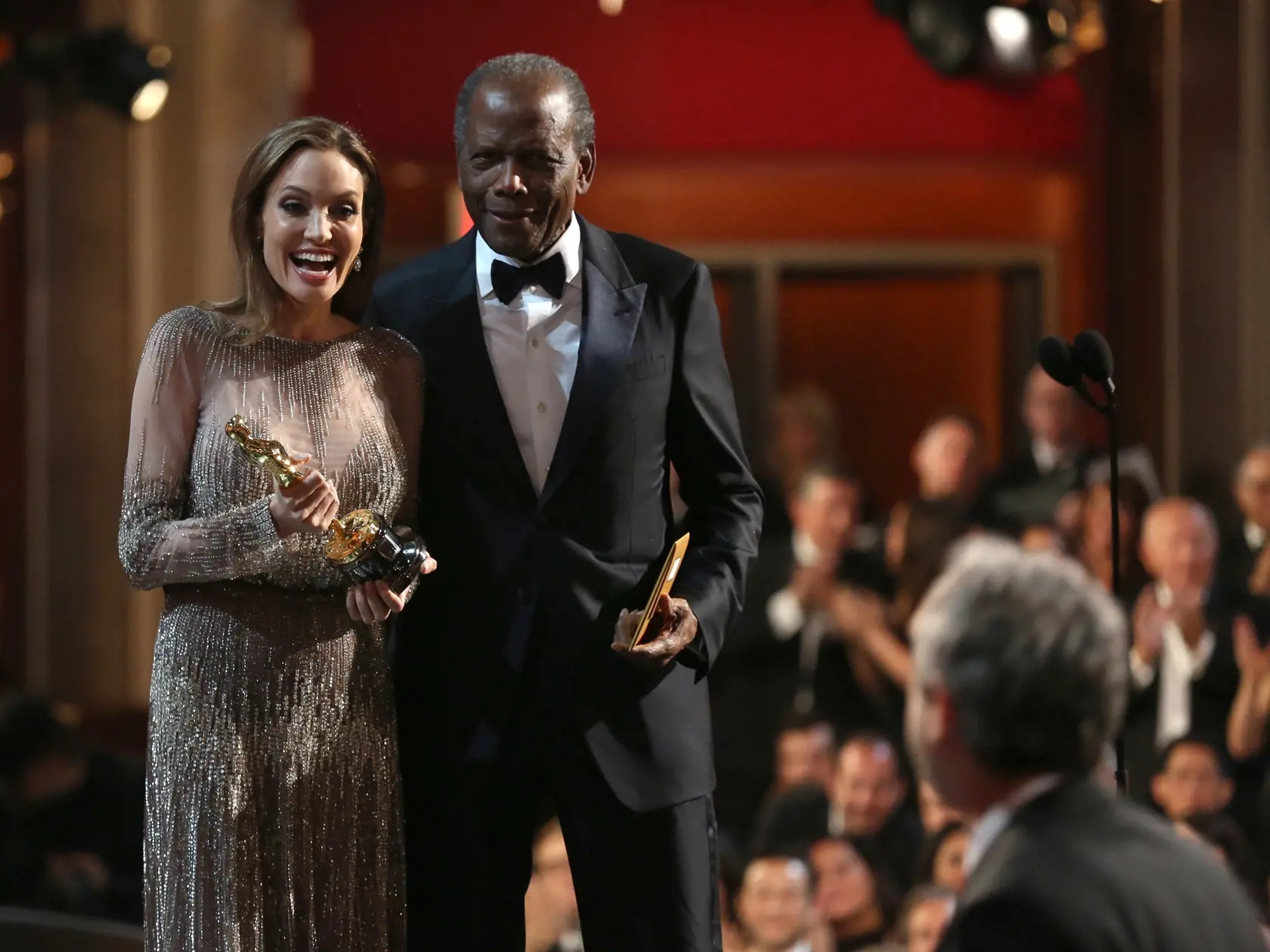 Presenters Angelina Jolie, left, and Sidney Poitier present the award for best director during the Oscars during the Oscars at the Dolby Theatre on Sunday, March 2, 2014, in Los Angeles.  (Photo by Matt Sayles/Invision/AP)