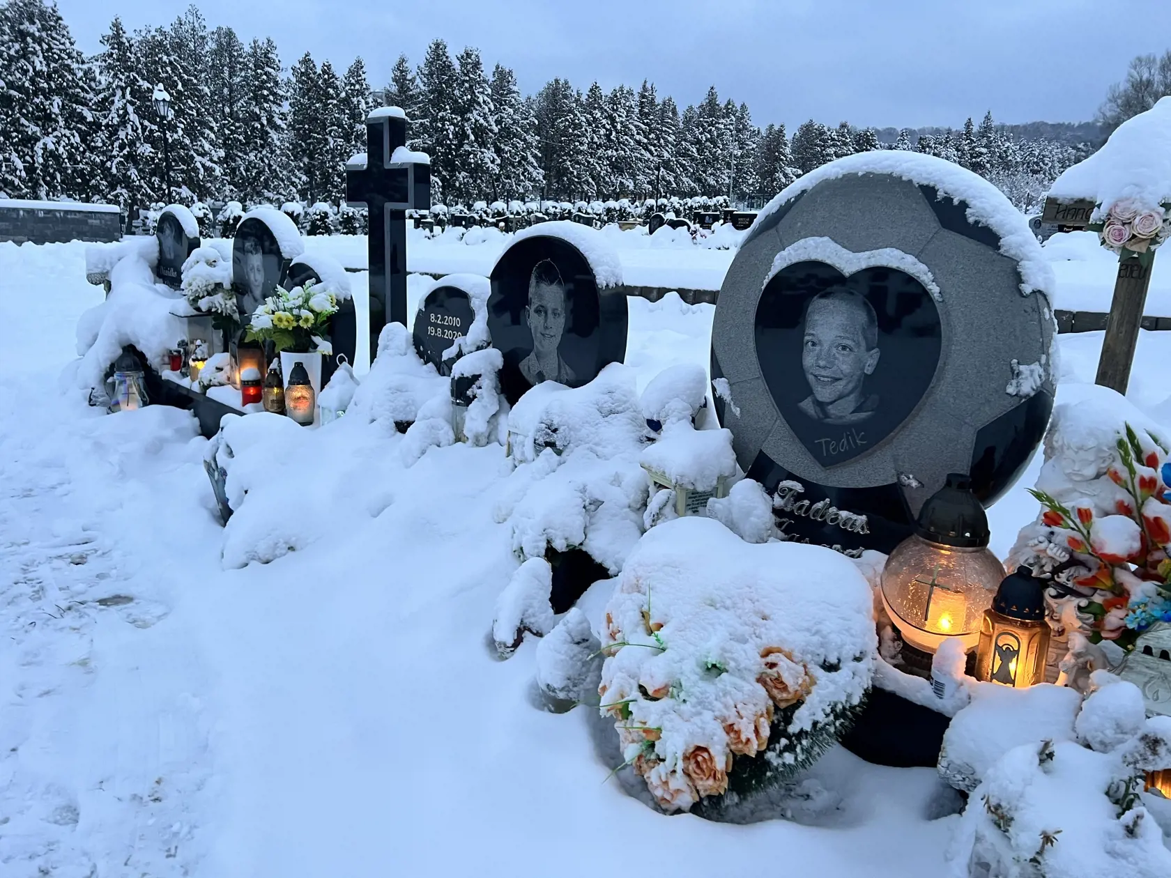 Hrobčeky štyroch malých futbalistov sú stále krásne udržiavané. Ani návaly snehu nezabránili ich príbuzných zapáliť im tam sviečku.