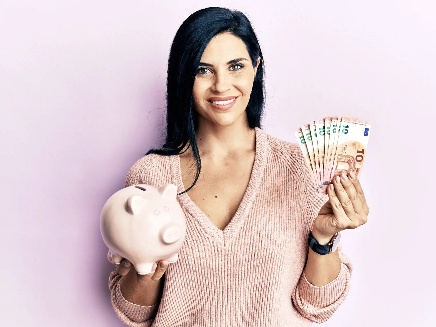 Young caucasian woman holding euro banknotes and piggy bank smiling with a happy and cool smile on face. showing teeth. 