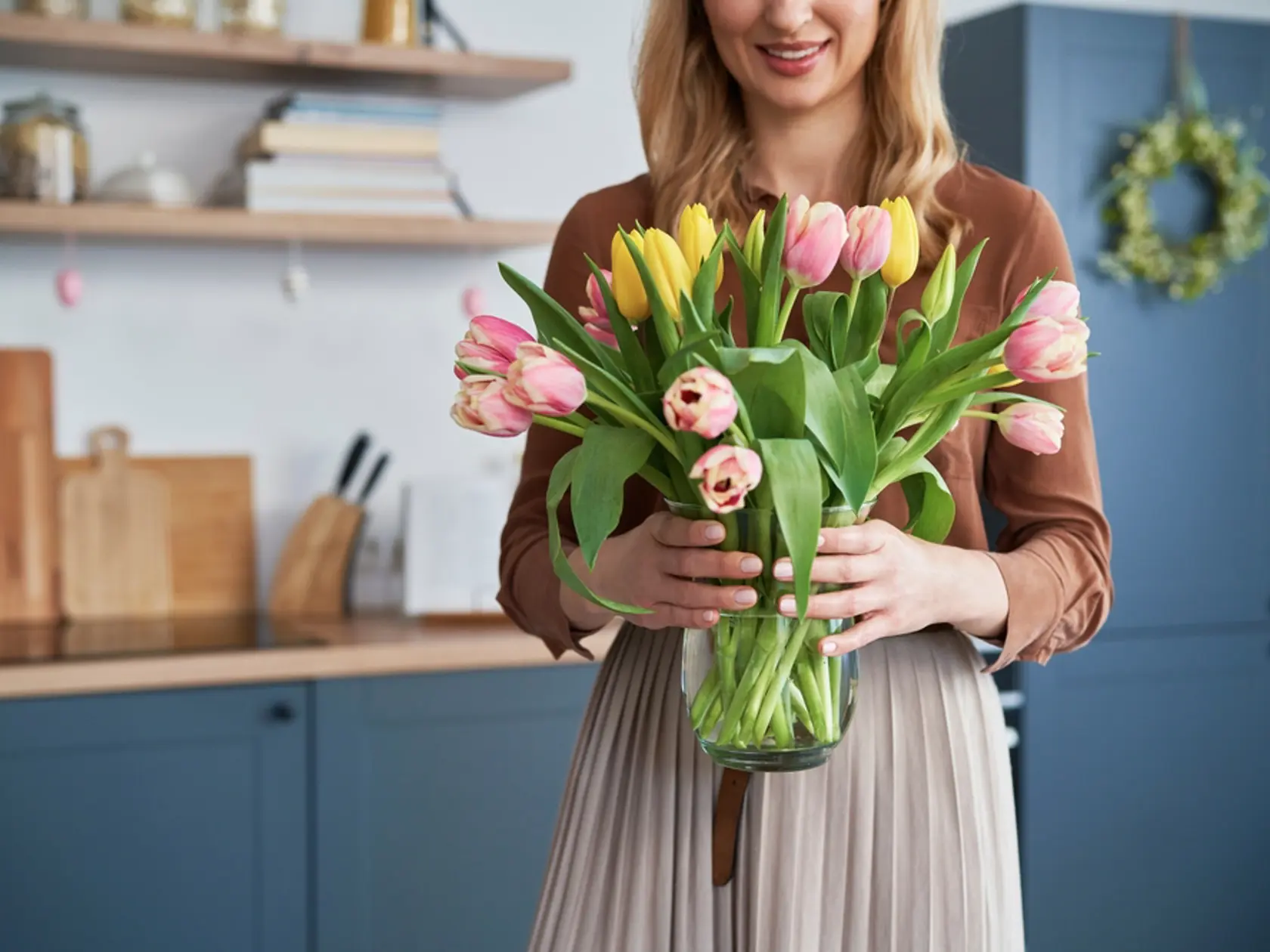 Caucasian woman holding bouquet of fresh tulips 