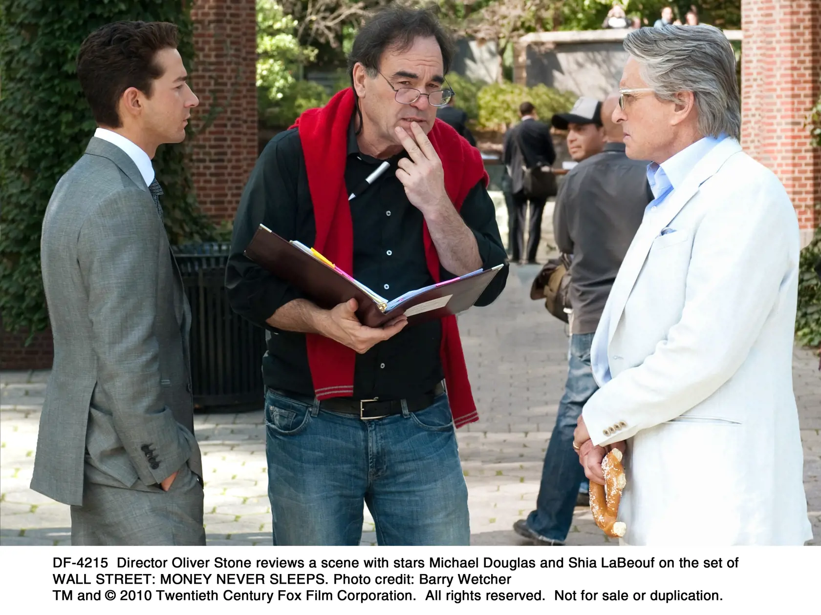 DF-4215  Director Oliver Stone reviews a scene with stars Michael Douglas and Shia LaBeouf on the set of WALL STREET: MONEY NEVER SLEEPS. 