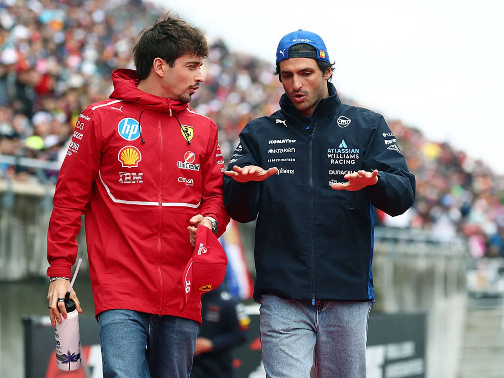 SUZUKA, JAPAN - APRIL 06: Charles Leclerc of Monaco and Scuderia Ferrari and Carlos Sainz of Spain and Williams talk on the drivers parade prior to the F1 Grand Prix of Japan at Suzuka Circuit on April 06, 2025 in Suzuka, Japan. (Photo by Clive Rose/Getty Images)