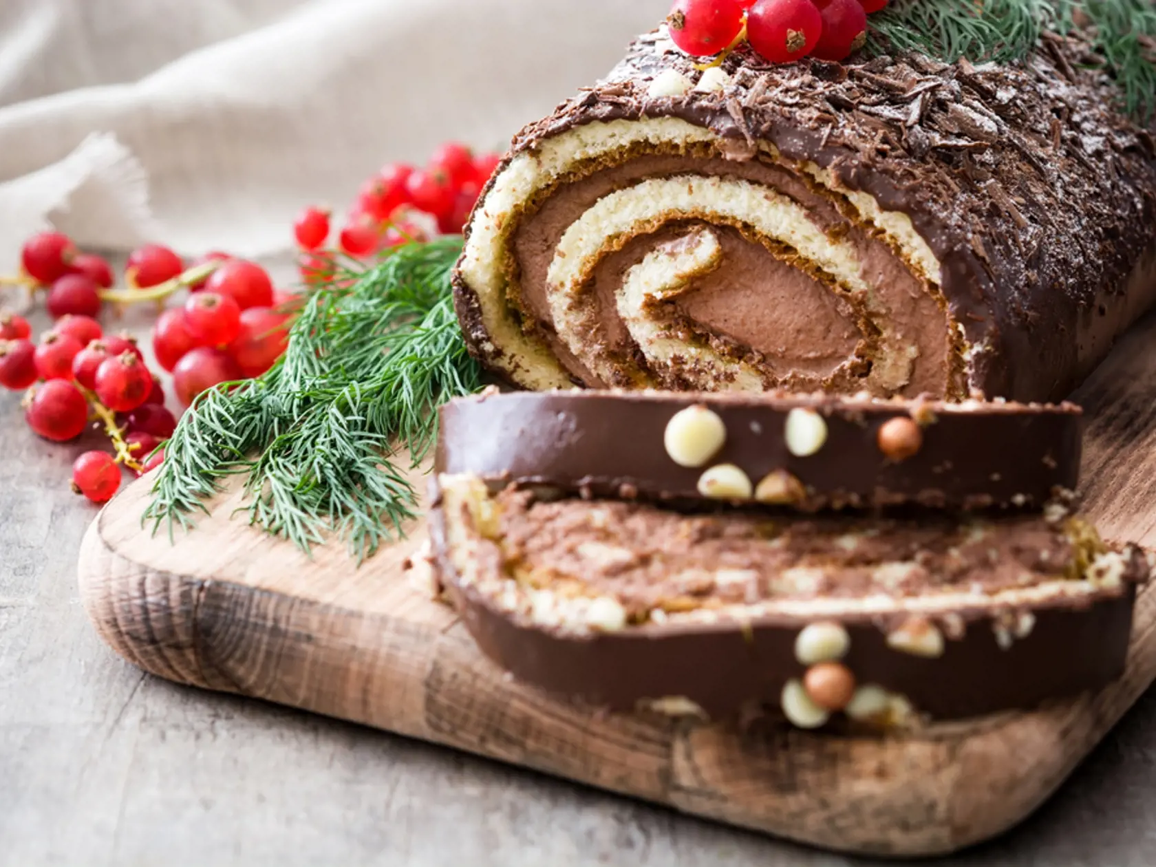 Chocolate,Yule,Log,Christmas,Cake,With,Red,Currant,On,Wooden
