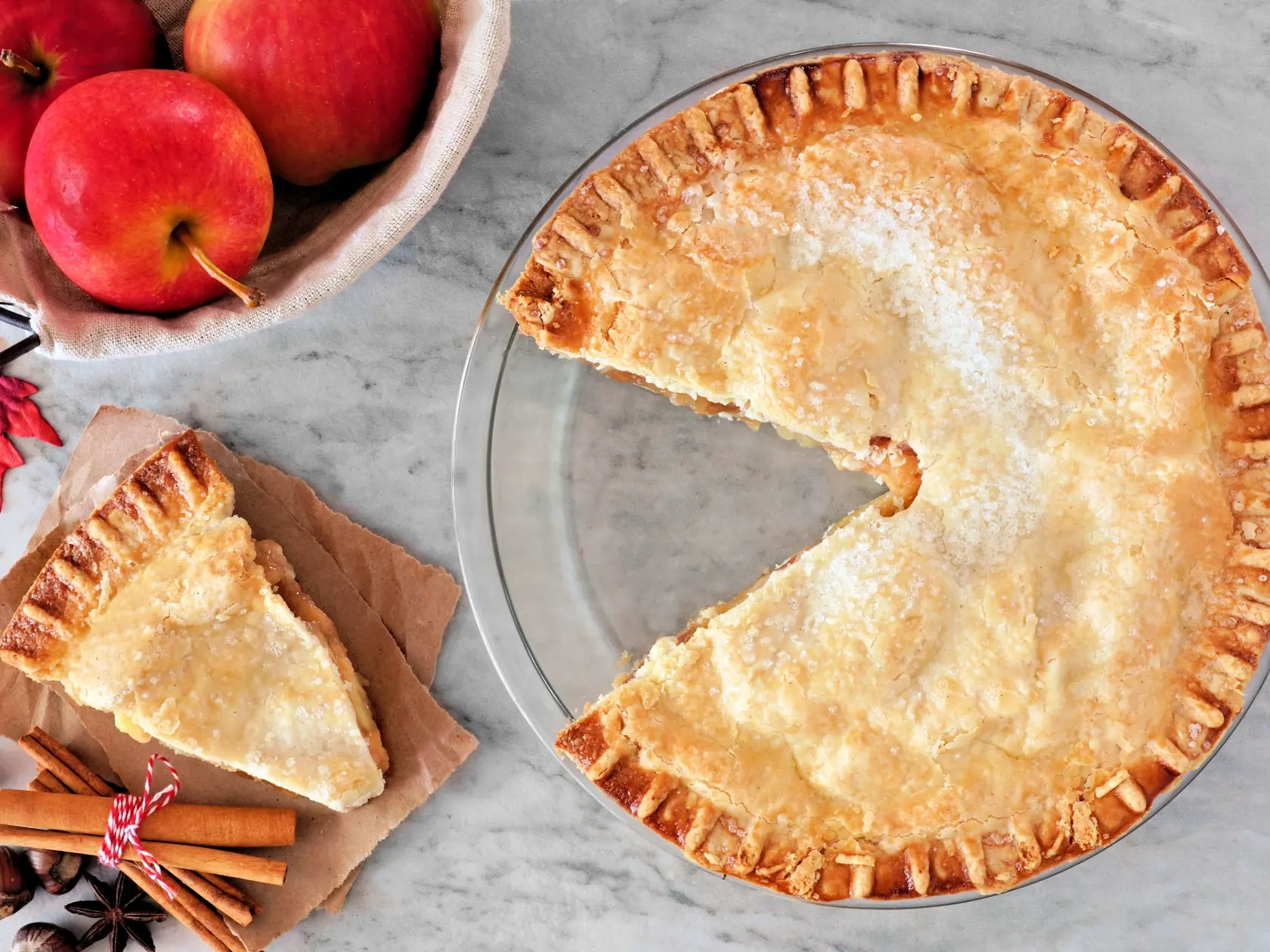 Apple autumn pie, overhead scene with cut slice on marble background