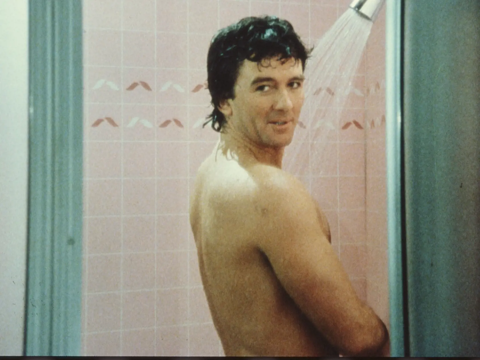 In a scene from the American television series 'Dallas,' American actor Patrick Duffy (as Bobby Ewing) stands in the shower and looks over his shoulder in an episode called 'Blast From the Past,' May 1986. (Photo by CBS Photo Archive/Getty Images) 