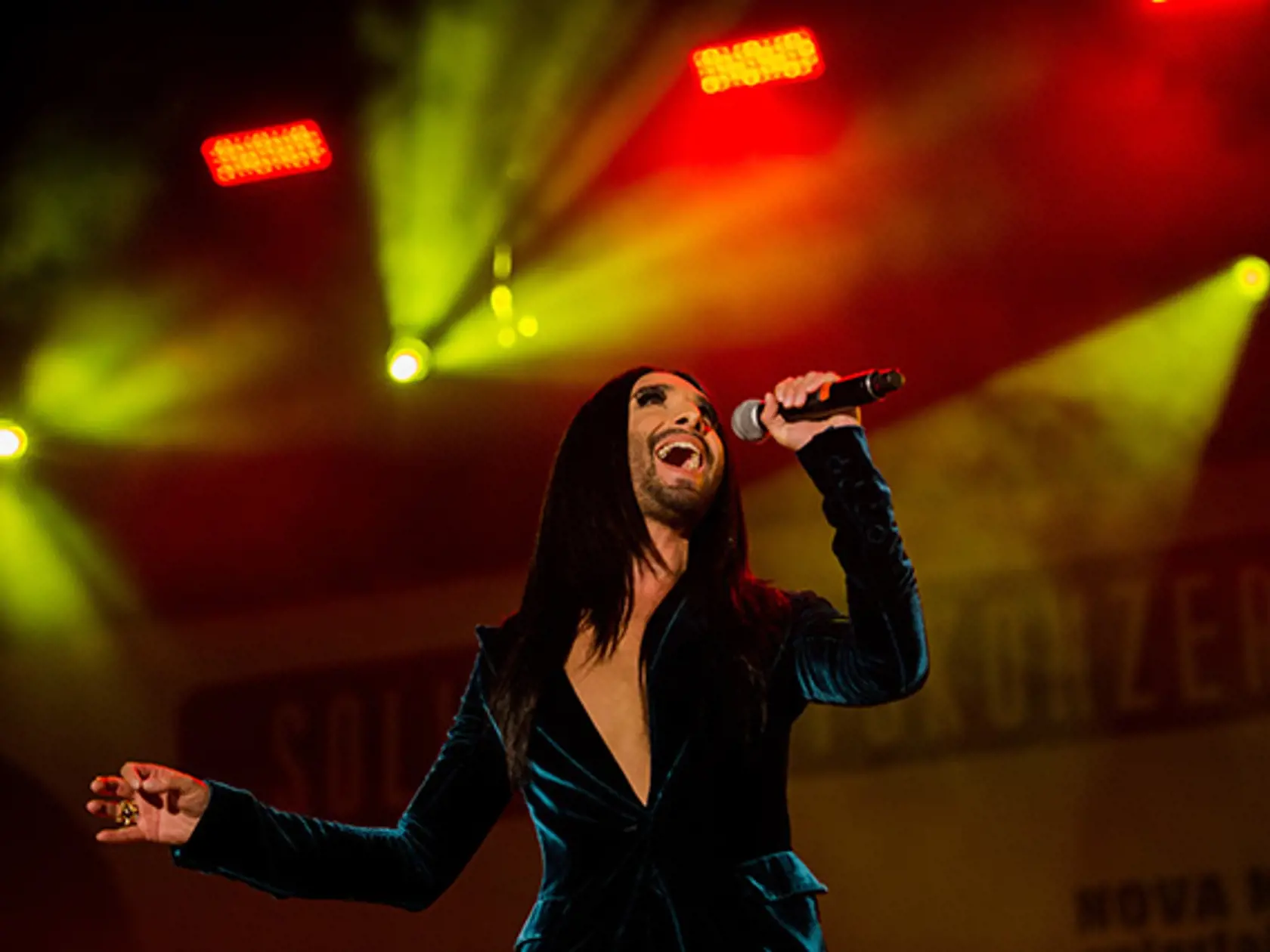 Conchita Wurst performs on stage during a "Voices for Refugees" solidarity concert at Heldenplatz square in Vienna, Austria, Saturday, Oct. 03, 2015. (AP Photo/Christian Bruna)