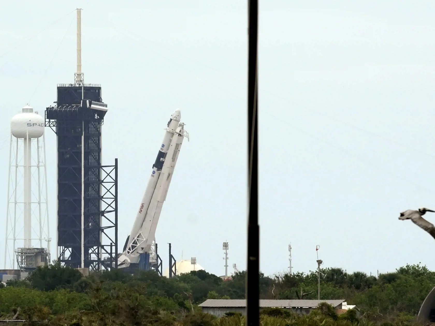 JB 6 Mys Canaveral - Raketa SpaceX Falcon 9  s vesmírnou loďou Crew Dragon pred štartom z Kennedyho vesmírneho strediska na Myse Kanaveral na Floride 26. mája 2020. Raketa na Medzinárodnú vesmírnu stanicu (ISS) po prvý raz povezie aj ľudskú posádku - astronautov Douga Hurleyho a Boba Behnkena. FOTO TASR/AP 

The SpaceX Falcon 9, with the Crew Dragon spacecraft on top of the rocket, is raised onto Launch Pad 39-A Tuesday, May 26, 2020, at Kennedy Space Center, Fla. Two astronauts will fly on the 