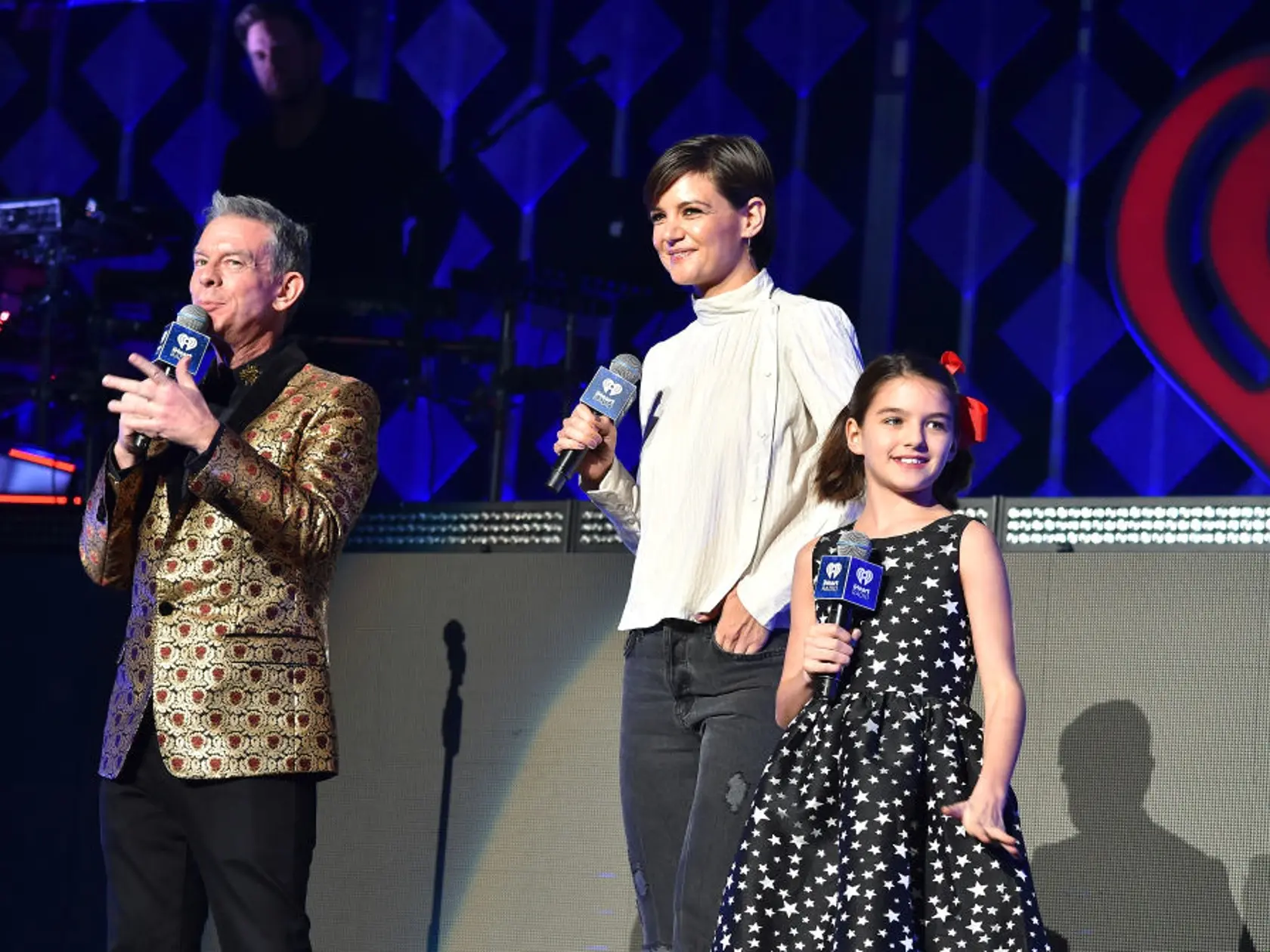 NEW YORK, NY - DECEMBER 08:  Elvis Duran, Katie Holmes and Suri Cruise speak at Z100's Jingle Ball 2017 on December 8, 2017 in New York City.  (Photo by Theo Wargo/Getty Images for iHeartMedia)