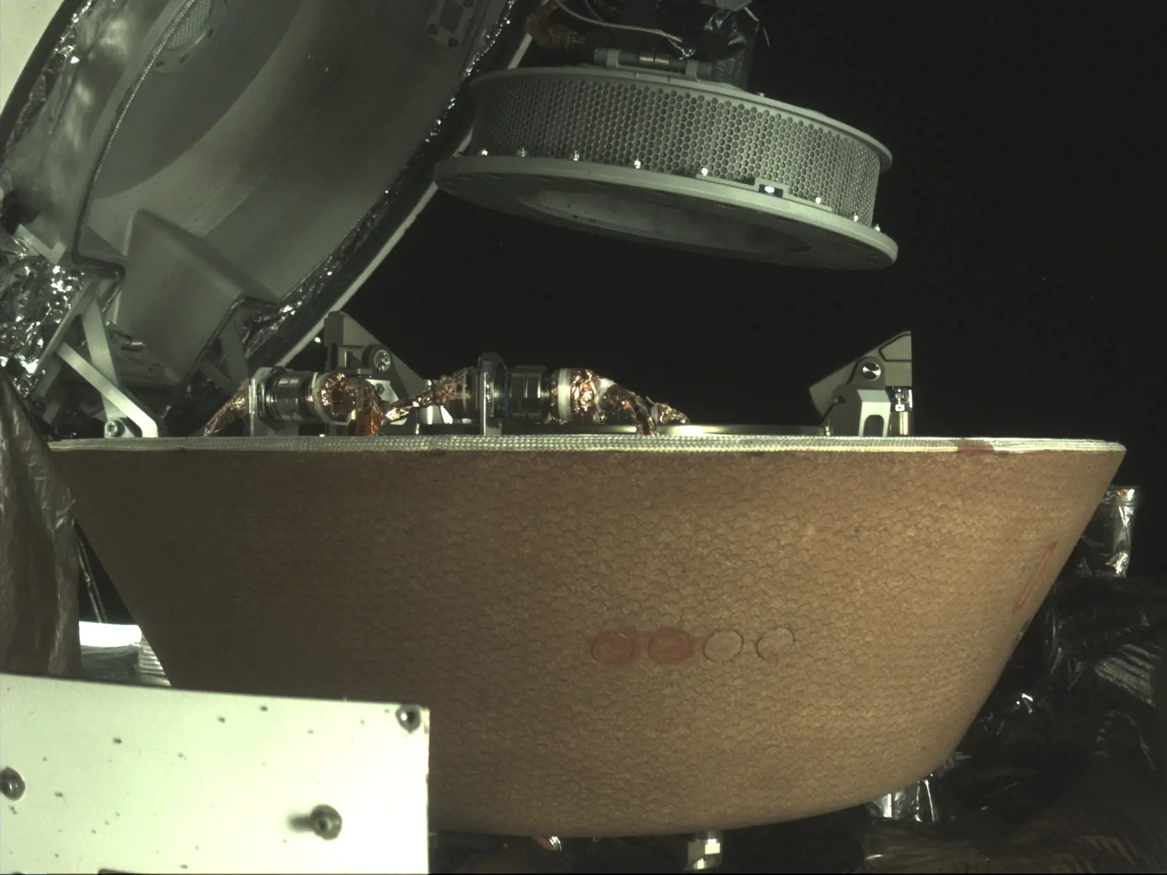 Na nedatovanej snímke nádoba so vzorkami sa vznáša nad kapsulou na kozmickej sonde Osiris-Rex v blízkosti asteroidu Bennu.
