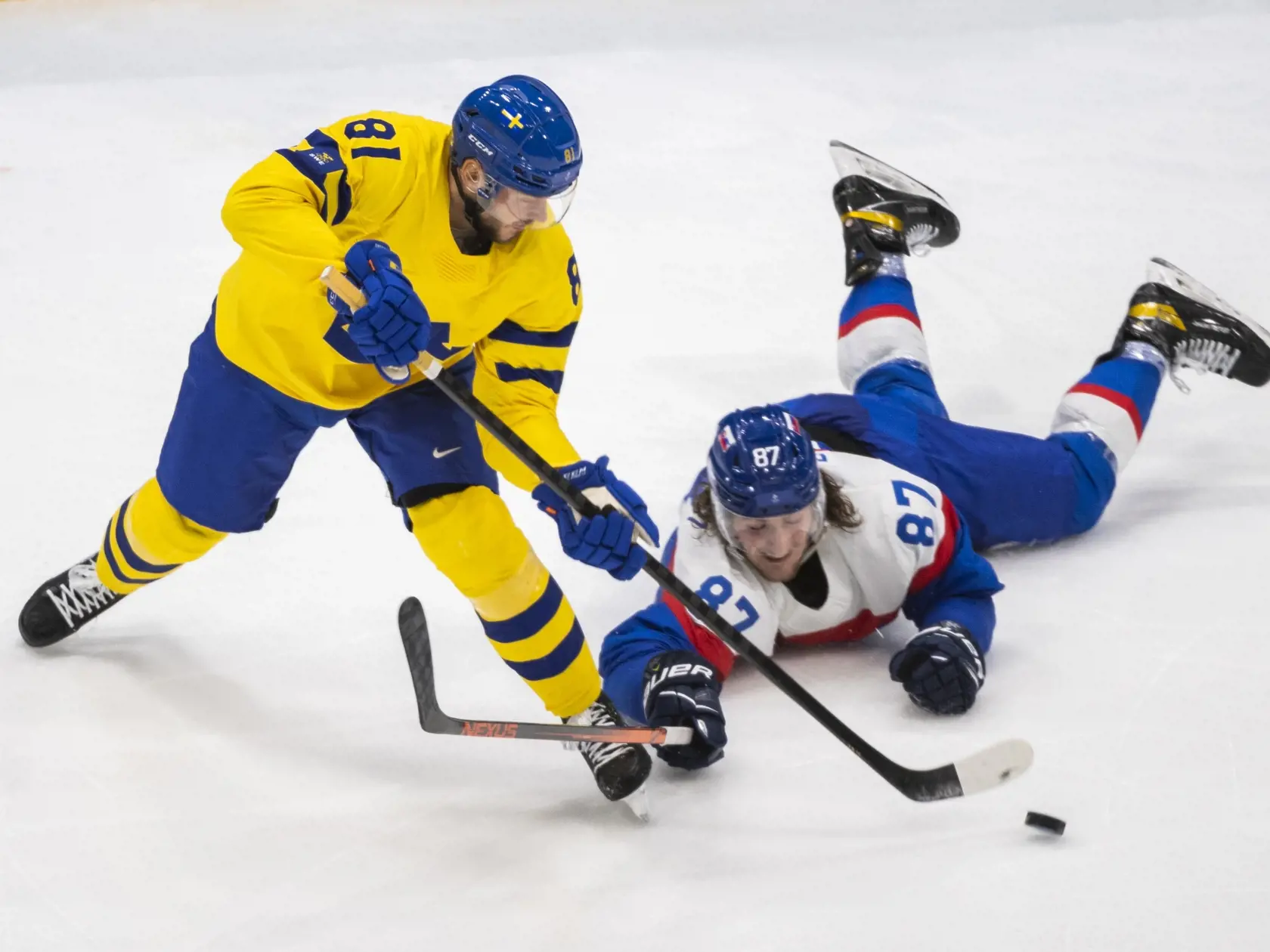 Na snímke zľava hráč Švédska Theodor Lennström a hokejista Slovenska Pavol Regenda v zápase olympijského turnaja v hokeji mužov o bronz Slovensko - Švédsko na ZOH 2022 v Pekingu v sobotu 19. februára 2022. FOTO TASR - Jaroslav Novák
