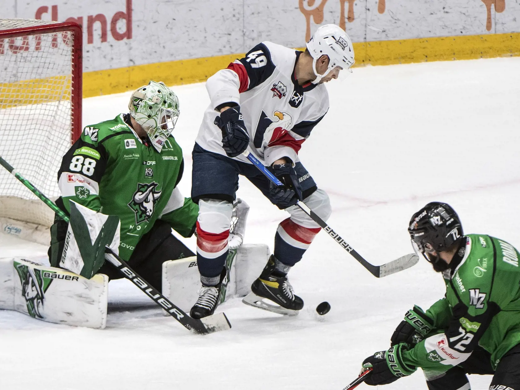 Na snímke vľavo brankár Jakub Lackovič (Nové Zámky) a uprostred Samuel Takáč (Slovan) v zápase 11. kola Tipos extraligy HC Slovan Bratislava - HC Nové Zámky v Bratislave v nedeľu 24. októbra 2021. FOTO TASR - Pavel Neubauer



