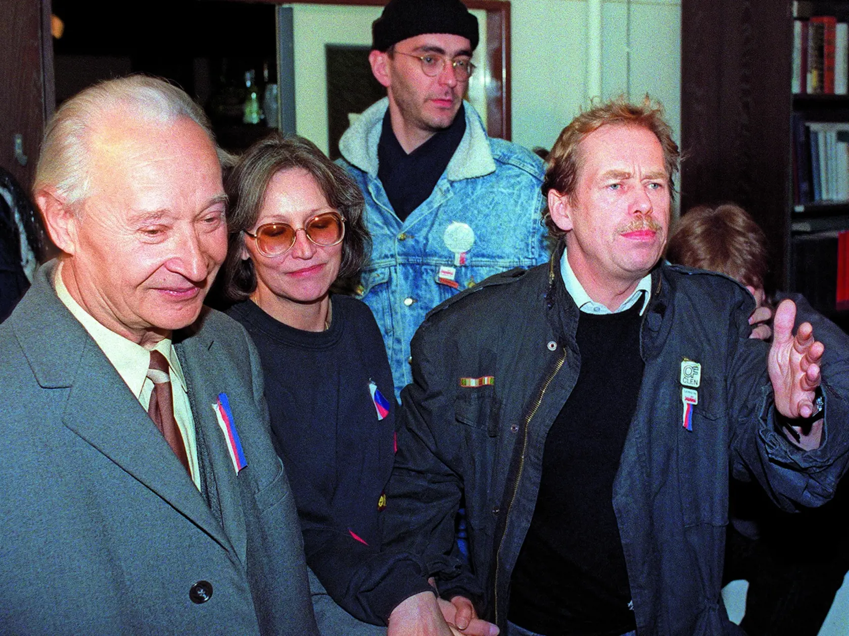 Vaclav Havel (R), a dissident playwright and leading member of the Czechoslovak opposition Civic Forum, who drafted large parts of Charter 77, the declaration which helped attract international attention to the civil rights abuses in Czechoslovakia, former "Prague Spring" leader Slovak Alexander Dubcek (L) and Czech dissident singer Marta Kubisova (C) join hands as they walk to address a rally of 200,000 demonstrators gathered on Prague's Wenceslas Square, calling for the resignation of the comm