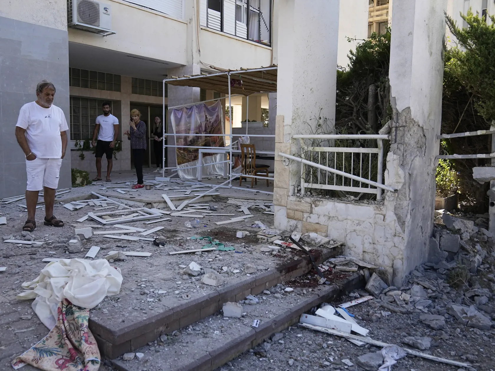JB 14 Aškelon - Obyvatelia sa pozerajú na škody po raketovom útoku z pásma Gazy v izraelskom meste Aškelon 7. októbra 2023. Vodca islamistického hnutia Hamas oznámil, že táto ozbrojená skupina začala novú vojenskú operáciu proti Izraelu. V Jeruzaleme sa rozozvučali sirény oznamujúce letecký poplach. TASR správu prevzala v sobotu z agentúr AP a AFP. FOTO TASR/AP

Residents look at damage after a rocket attack from the Gaza Strip in Ashkelon, Israel, on Saturday, Oct. 7, 2023. Palestinian militant