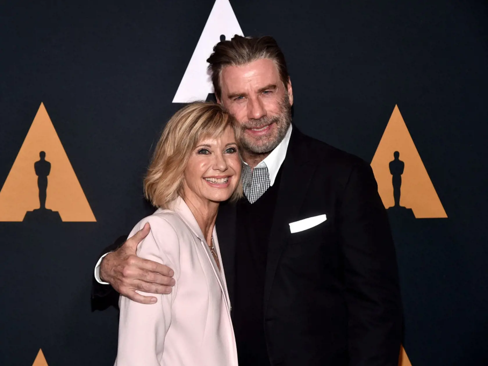 BEVERLY HILLS, CA - AUGUST 15:  Olivia Newton-John (L) and John Travolta attend the "Grease" 40th anniversary screening at Samuel Goldwyn Theater on August 15, 2018 in Beverly Hills, California.  (Photo by Alberto E. Rodriguez/Getty Images)