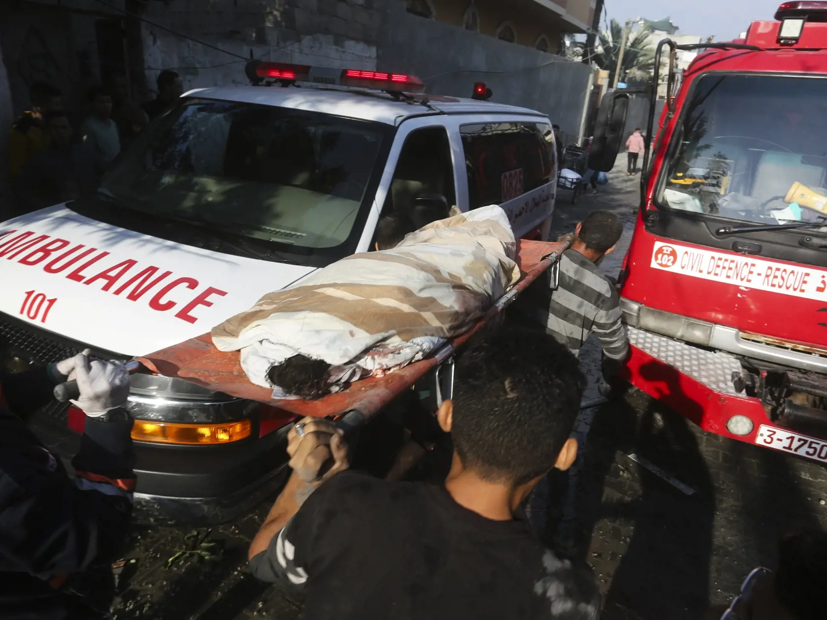 Palestínčania evakuujú zranené osoby po izraelskom leteckom útoku v meste Rafah na juhu Pásma Gazy v piatok 1. decembra 2023.