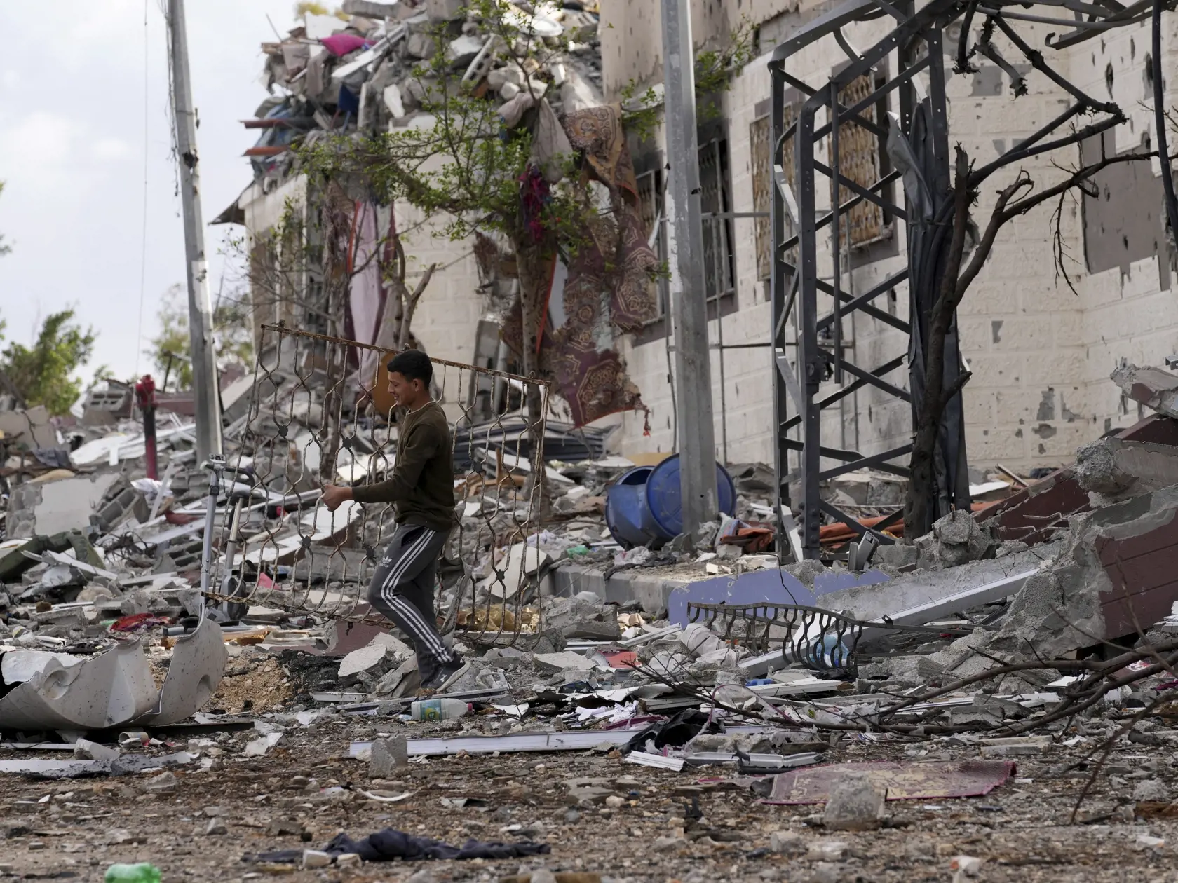 Palestínčan zbiera svoje veci pri zničenom dome po izraelskom bombardovaní na juhovýchode Gazy, v pásme Gazy 28. novembra 2023 počas piateho dňa prímeria medzi palestínskym radikálnym hnutím Hamas a Izraelom.