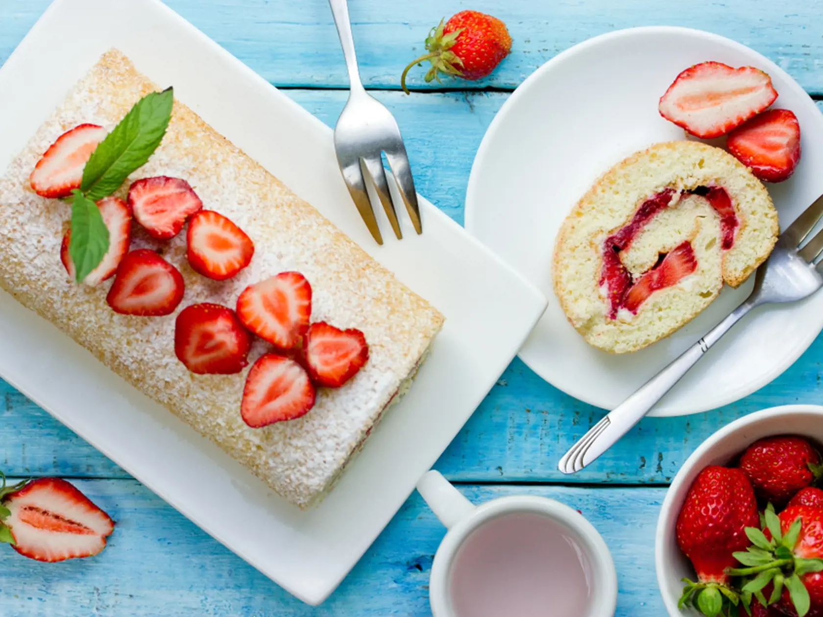 Strawberry,Cake,Roll,On,Blue,Wooden,Background,Top,View