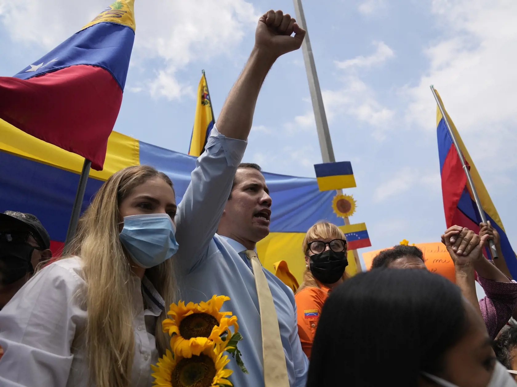 PK 62 Caracas - Líder venezuelskej opozície Juan Guaidó (uprostred) skanduje a jeho manželka Fabiana Rosalesová (vľavo) drží slnečnice počas protestu proti ruskej invázii na Ukrajine pred kanceláriou Európskej Únie vo venezuelskej metropole Caracas vo štvrtok 3. marca 2022. FOTO TASR/AP

Venezuela opposition leader Juan Guaido raises his fist as his wife Fabiana Rosales holds sunflowers, during a protest against Russian's invasion of the Ukraine, outside the European Union offices in Caracas, Ve