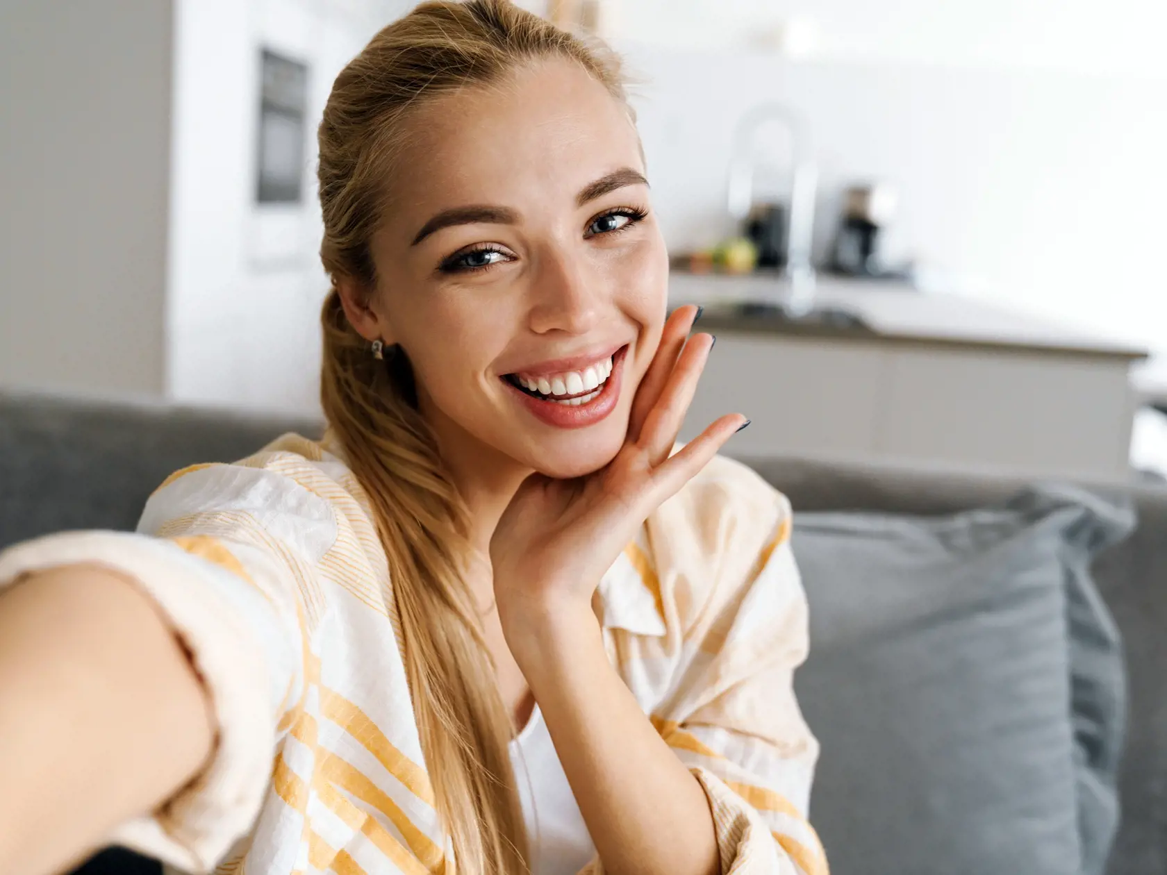 Happy,Blonde,Woman,Smiling,While,Taking,Selfie,Photo,At,Home
