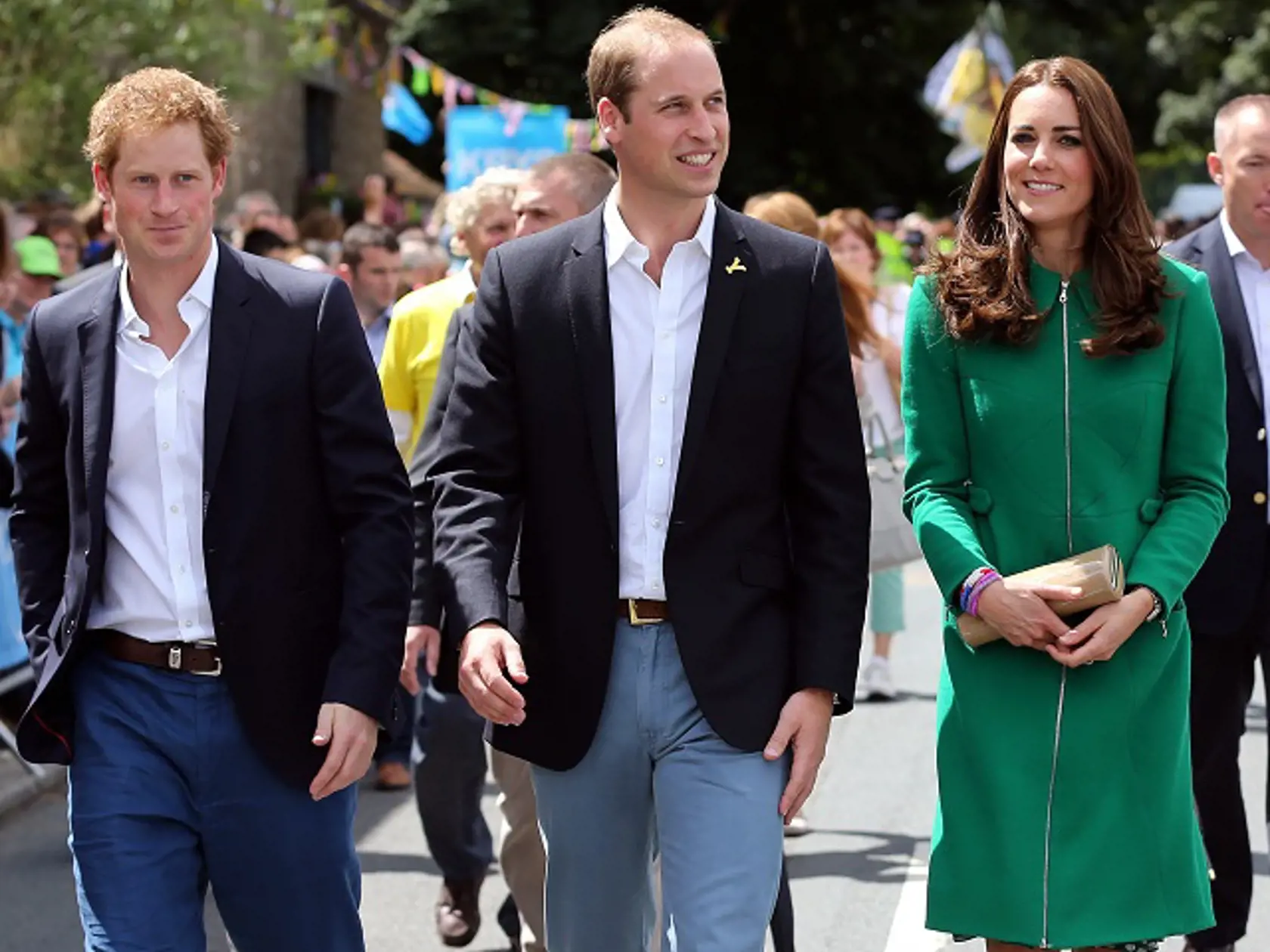 Prince William, centre, Kate Duchess of Cambridge and Prince Harry walk along the street to celebrate the start of the Tour de France in Yorkshire at West Tanfield, England, Saturday, July 5, 2014. The 198 competitors in the 101st Tour de France have started their grueling three-week ride through four countries before ending the world's greatest cycling race in Paris on July 27. (AP Photo/Scott Heppell/Pool)