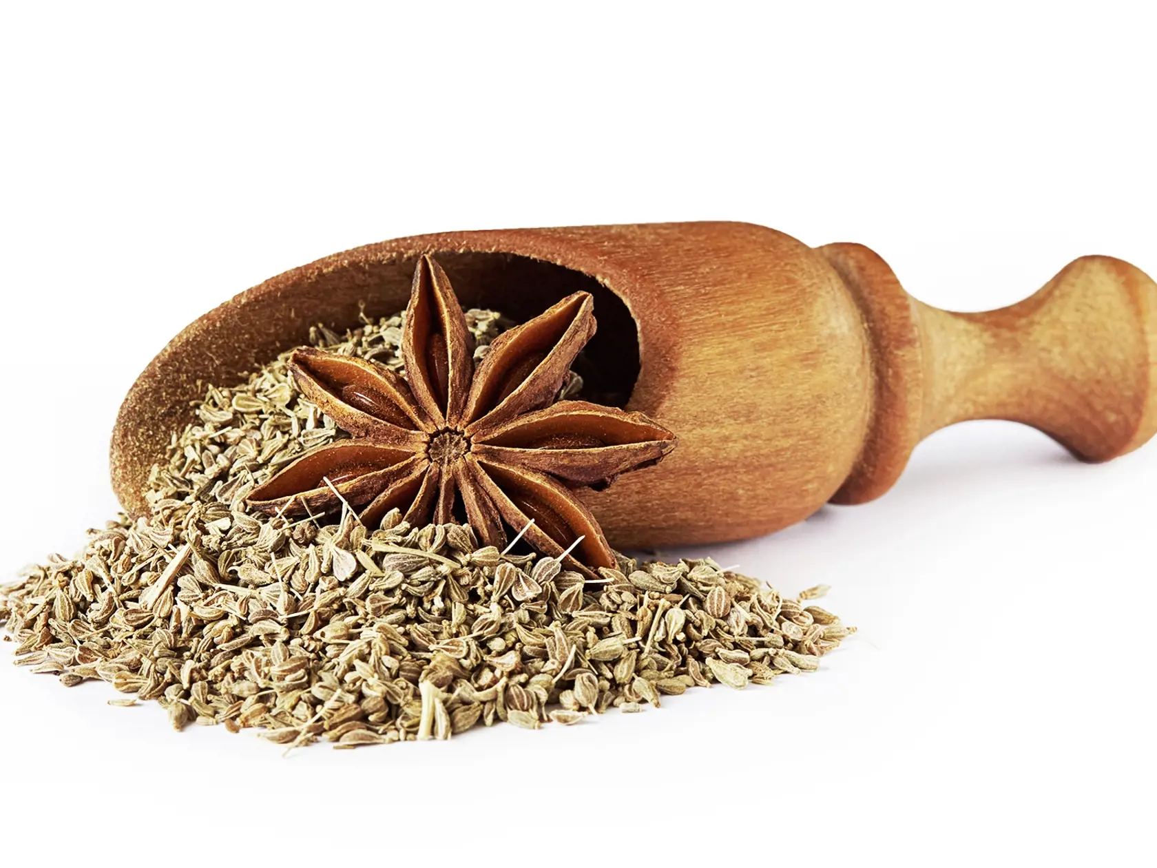 Star anise (Illicium verum) and anise seed, also known as aniseed (Pimpinella anisum) in wooden scoop isolated on white background