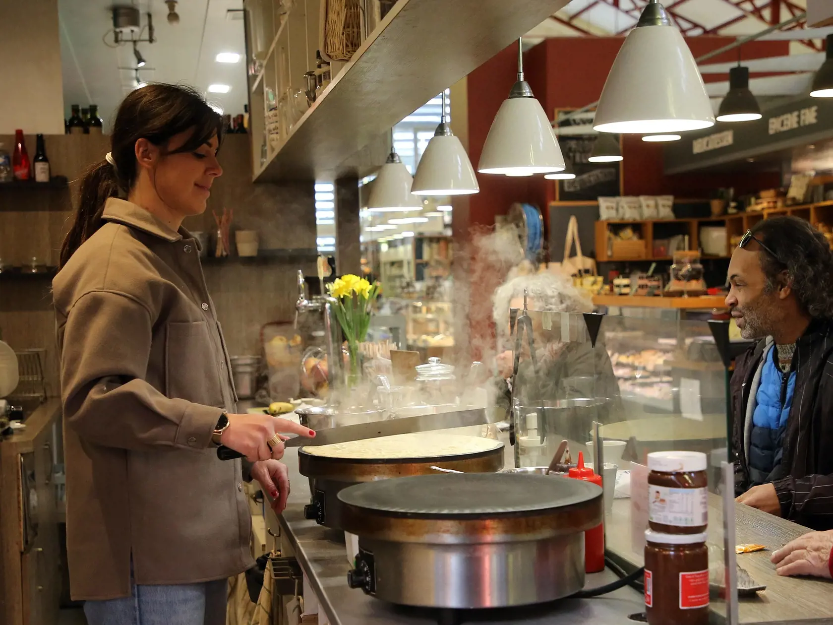 Ľudia bez ochranných rúšok sú na tržnici vo francúzskom kúpeľnom meste Biarritz, ktoré sa nachádza asi 18 kilometrov severne od hraníc so Španielskom v pondelok 14. marca 2022. Francúzi už nepotrebujú na vstup do interiérov rúška ani covid pasy. V krajine prestala v pondelok platiť väčšina zostávajúcich protiepidemických opatrení.