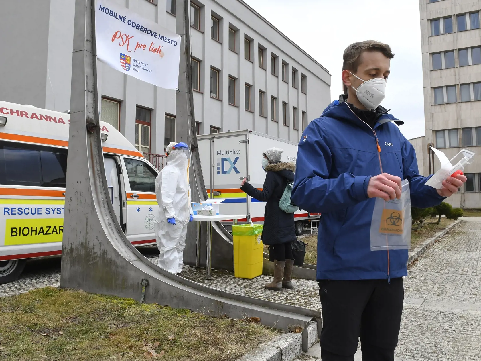 Na snímke mobilné odberové miesto pre LAMP testovanie na prítomnosť nového koronavírusu pred Úradom Prešovského samosprávneho kraja (PSK) v Prešove 14. februára 2022. Ide o testovanie kloktaním, ktoré má rovnakú citlivosť ako PCR testy, avšak jeho vyhodnocovanie trvá kratšie. Testovanie pred Úradom PSK potrvá predbežne do 18. februára 2022 ďalšia prevádzka tohto odberového miesta bude závisieť od záujmu ľudí. FOTO TASR - Milan Kapusta