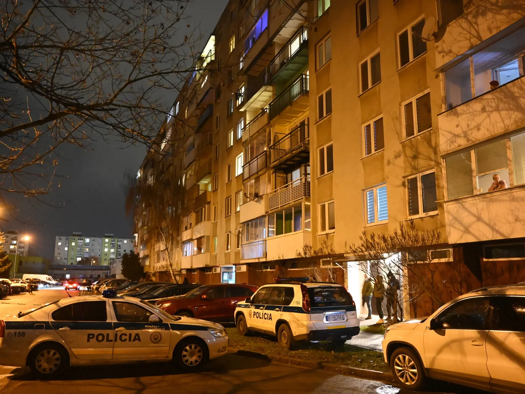 Na snímke policajné autá parkujú pred bytovým domom na Bieloruskej ulici v Michalovciach v utorok 17. januára 2023. V jednom z bytov na sídlisku v Michalovciach našli v utorok podvečer štyri osoby bez známok života. FOTO TASR - Roman Hanc
