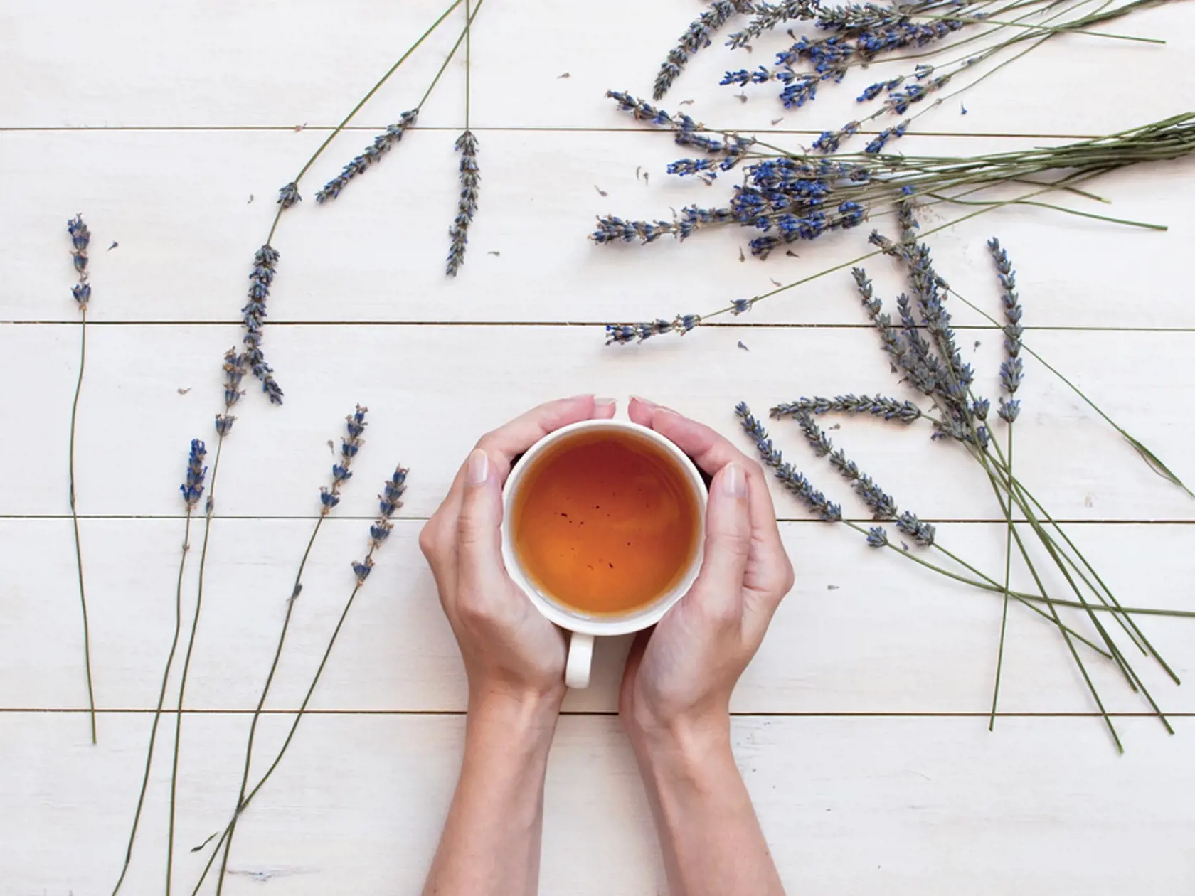 A,Cup,Of,Tea,In,Female,Hands,And,Lavender,On