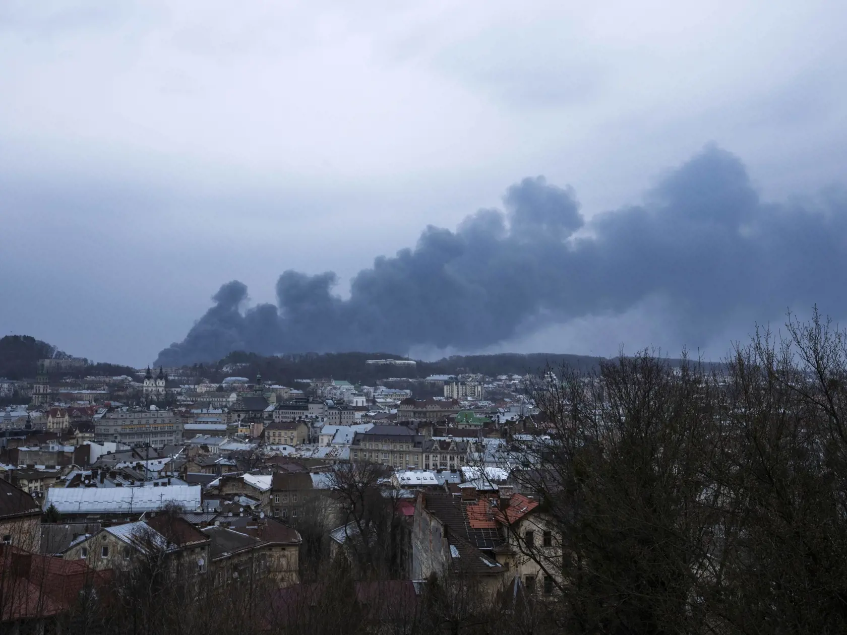 JB 62 Ľvov - V pozadí stúpa dym po explózii v Ľvove, na západe Ukrajiny 26. marca 2022. Tri mohutné explózie bolo v sobotu počuť blízko mesta Ľvov na západe Ukrajiny. Nad okrajom mesta stúpal hustý čierny dym, uviedli tamojšie úrady. TASR správu prevzala od agentúry Reuters a stanice BBC. K explóziám došlo v čase návštevy amerického prezidenta Joea Bidena v susednom Poľsku. Úrady v Ľvove vyzvali miestnych obyvateľov, aby sa pred útokmi ukryli. FOTO TASR/AP

Smoke rises in the sky in Lviv, wester
