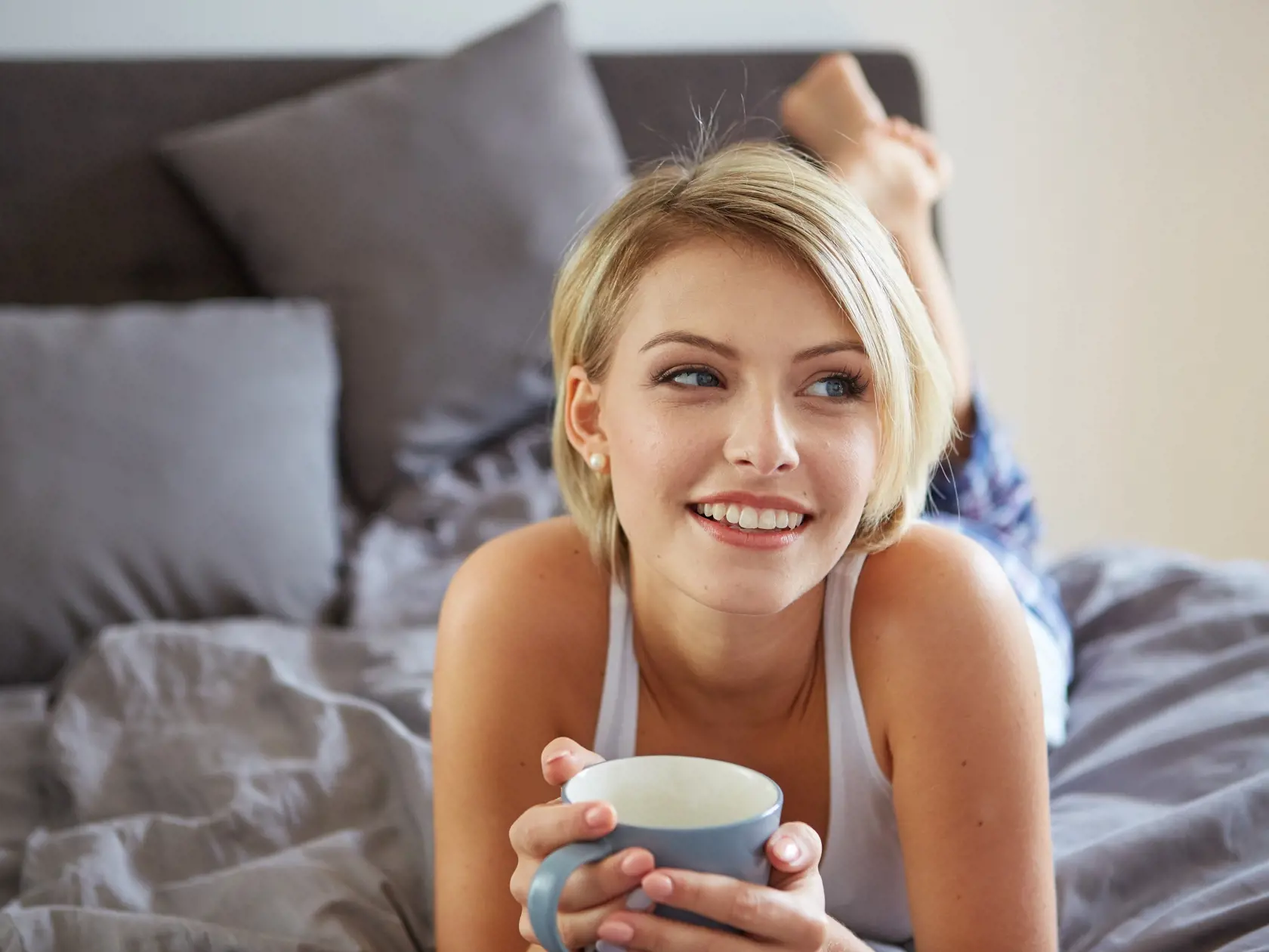 Happy,Smiling,Beautiful,Blond,Woman,Awaking,With,Cup,Of,Coffee