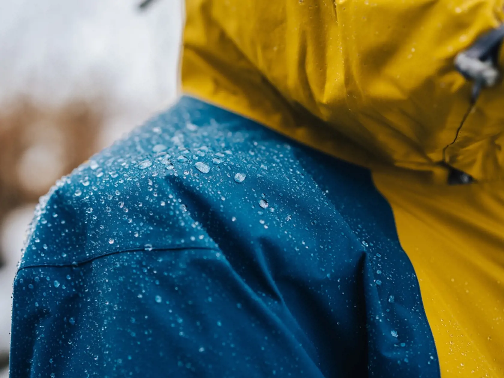 Detail photo of wateproof jacket with water droplets on it. Jacket using the gore-tex technology.
