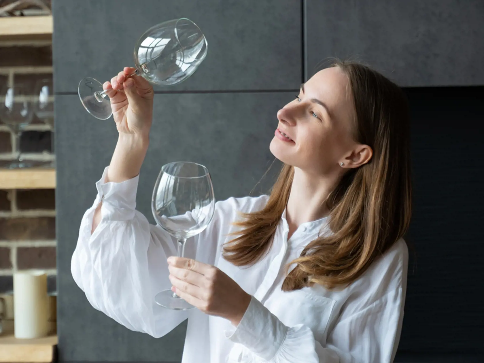 Woman,Takes,A,Glass,Out,Of,The,Dishwasher,While,Standing