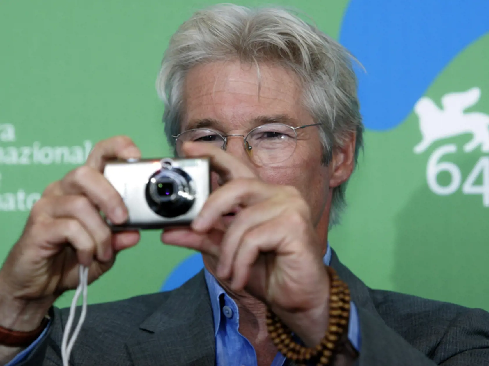Actor Richard Gere takes photos with a compact digital camera he was given by photographers at a photo session, as he was presenting the movie " I'm not there " competing in the  the 64th edition of the Venice Film Festival in Venice, Tuesday, Sept. 4, 2007.  (AP Photo/Domenico Stinellis)