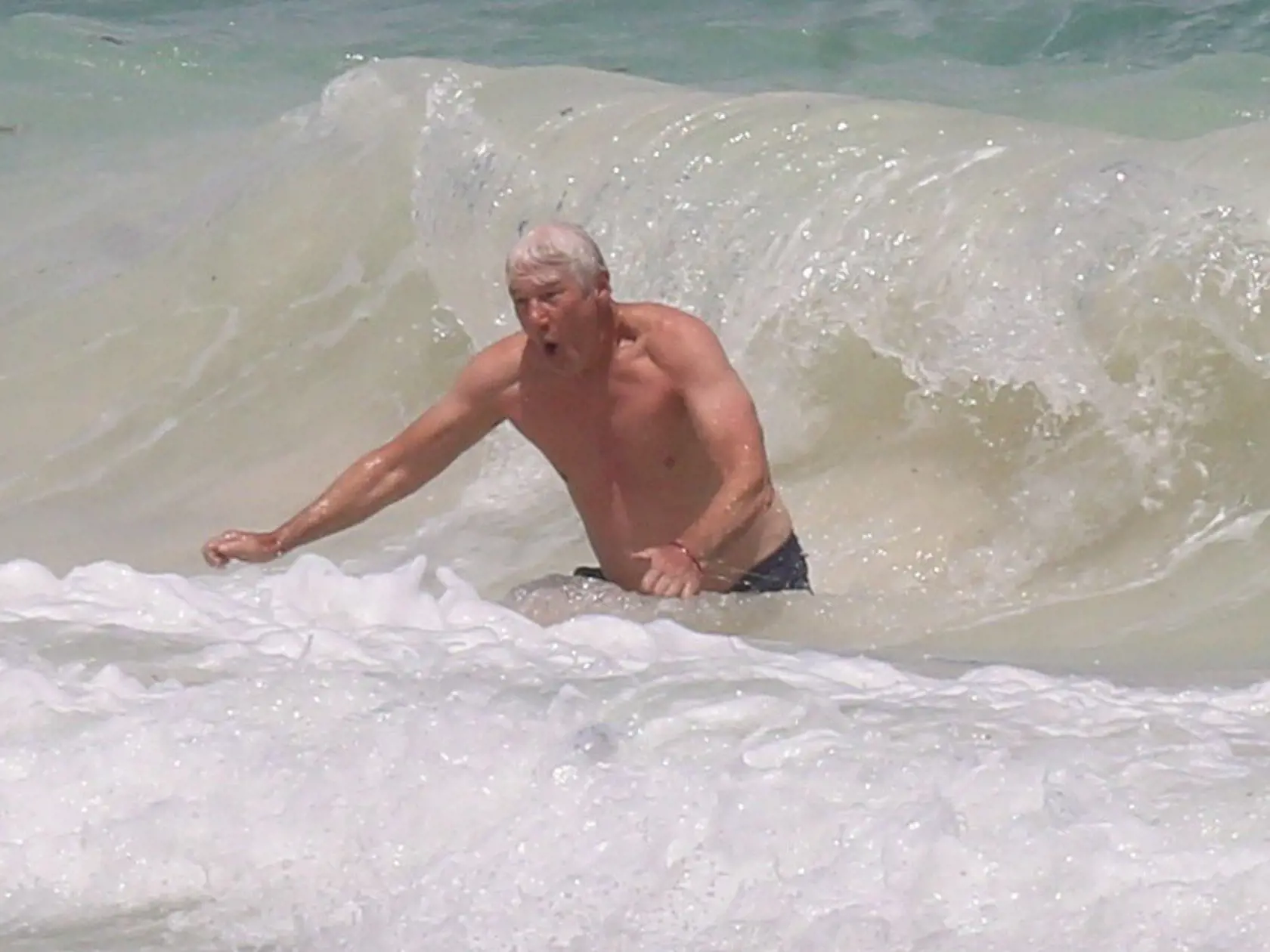 Exclusive... 52368802 Actor Richard Gere plays with Alejandra Silva's son Albert Friedland, after a solo body surfing session, while vacationing in Tulum, Mexico on April 4, 2017. Richard lifted the little guy up onto a canopy on the beach as his girlfriend Alejandra looked on and took video, as the three enjoy a relaxing and playful day at the beach. ***NO USE W/O PRIOR AGREEMENT - CALL FOR PRICING*** RESTRICTIONS APPLY: NO USA,NO UNITED KINGDOM,NO GERMANY,NO AUSTRALIA,NO SPAIN,NO CANADA, Image