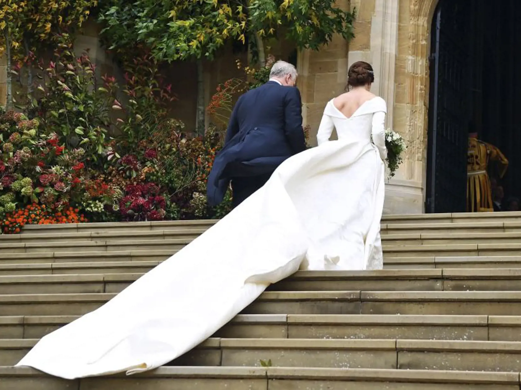 Britain's Princess Eugenie arrives with her father Prince Andrew for her wedding to Jack Brooksbank at St Georgeâs Chapel, Windsor Castle, near London, England, Friday Oct. 12, 2018. (Victoria Jones/Pool via AP)
