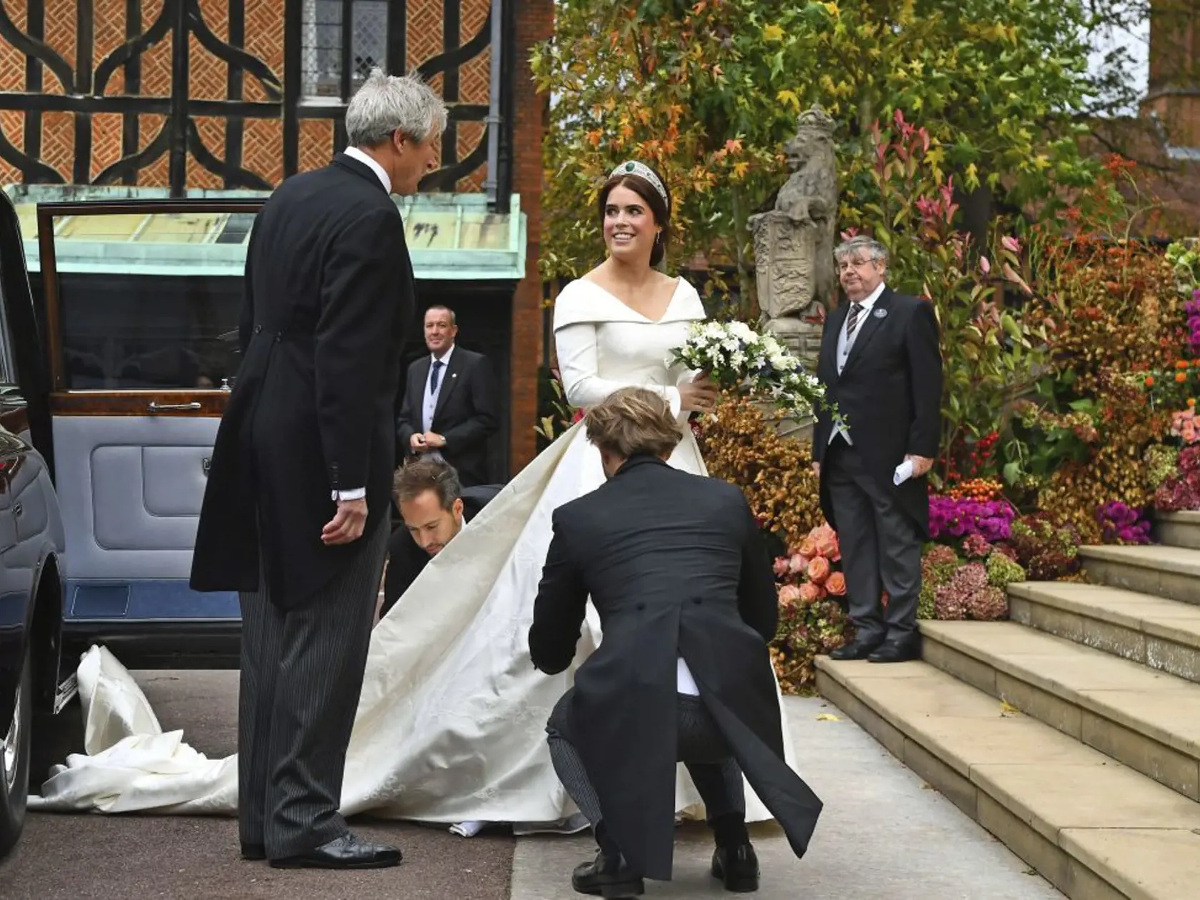 Britain's Princess Eugenie arrives with her father Prince Andrew for her wedding to Jack Brooksbank at St Georgeâs Chapel, Windsor Castle, near London, England, Friday Oct. 12, 2018. (Victoria Jones/Pool via AP)