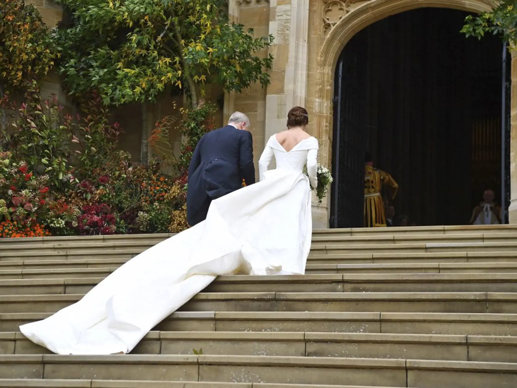 Britain's Princess Eugenie arrives with her father Prince Andrew for her wedding to Jack Brooksbank at St Georgeâs Chapel, Windsor Castle, near London, England, Friday Oct. 12, 2018. (Victoria Jones/Pool via AP)