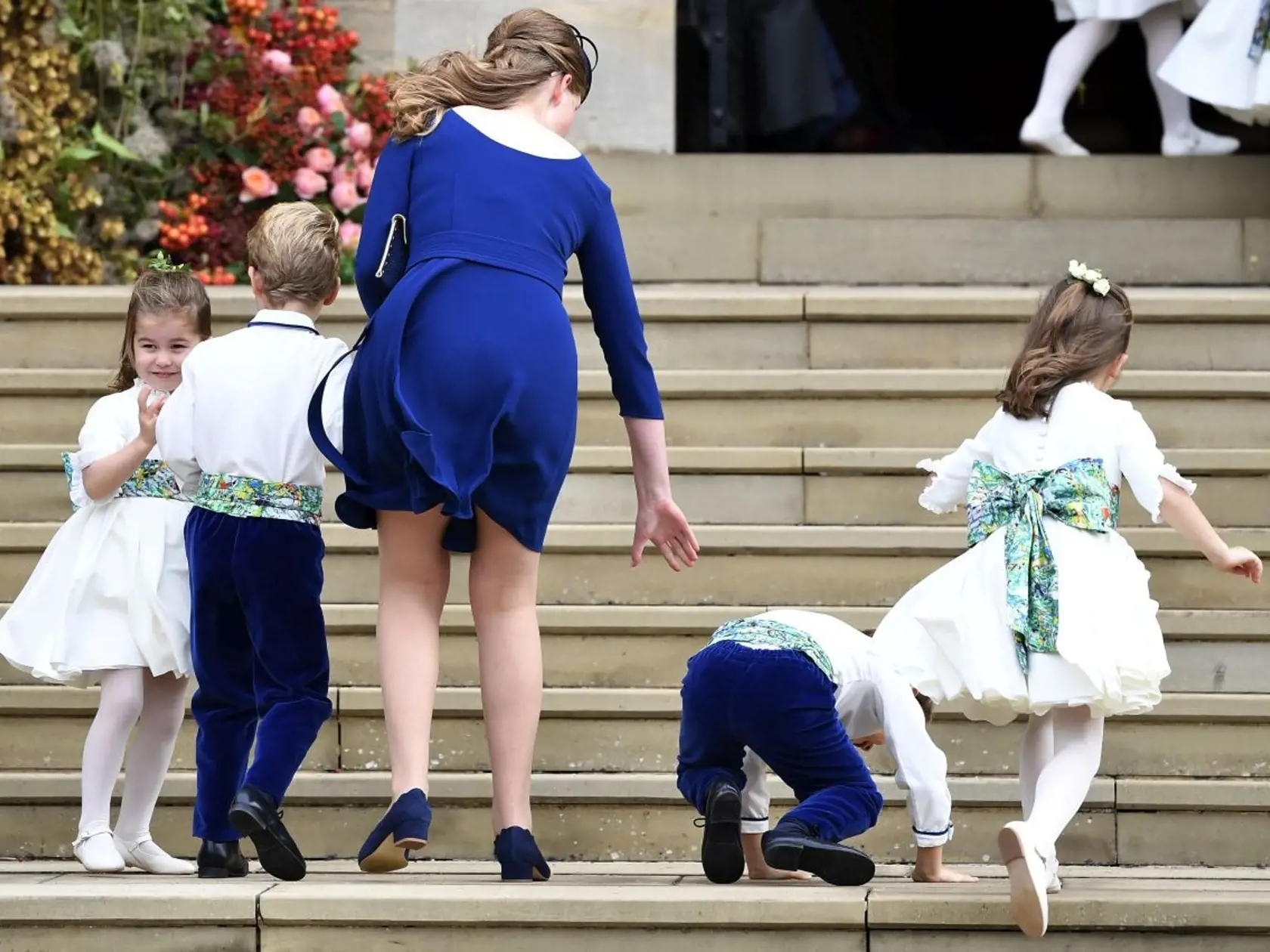 Princess Charlotte, left, arrives for the wedding of Princess Eugenie of York and Jack Brooksbank in St Georgeâs Chapel, Windsor Castle, near London, England, Friday Oct. 12, 2018. (Toby Melville, Pool via AP)