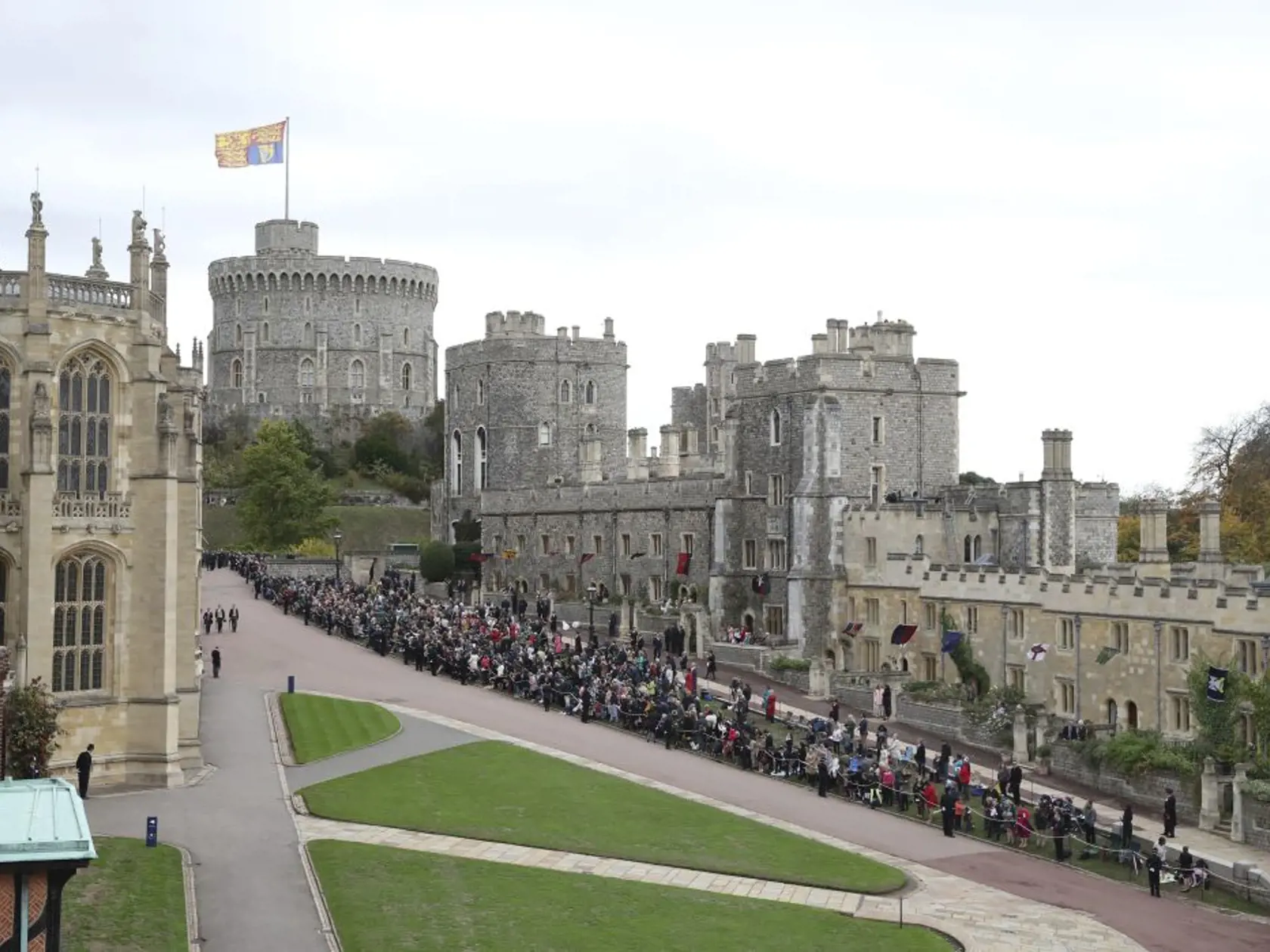Members of the public wait for the wedding of Princess Eugenie of York and Jack Brooksbank at St Georgeâs Chapel, Windsor Castle, near London, England, Friday Oct. 12, 2018. (Andrew Matthews, Pool via AP)