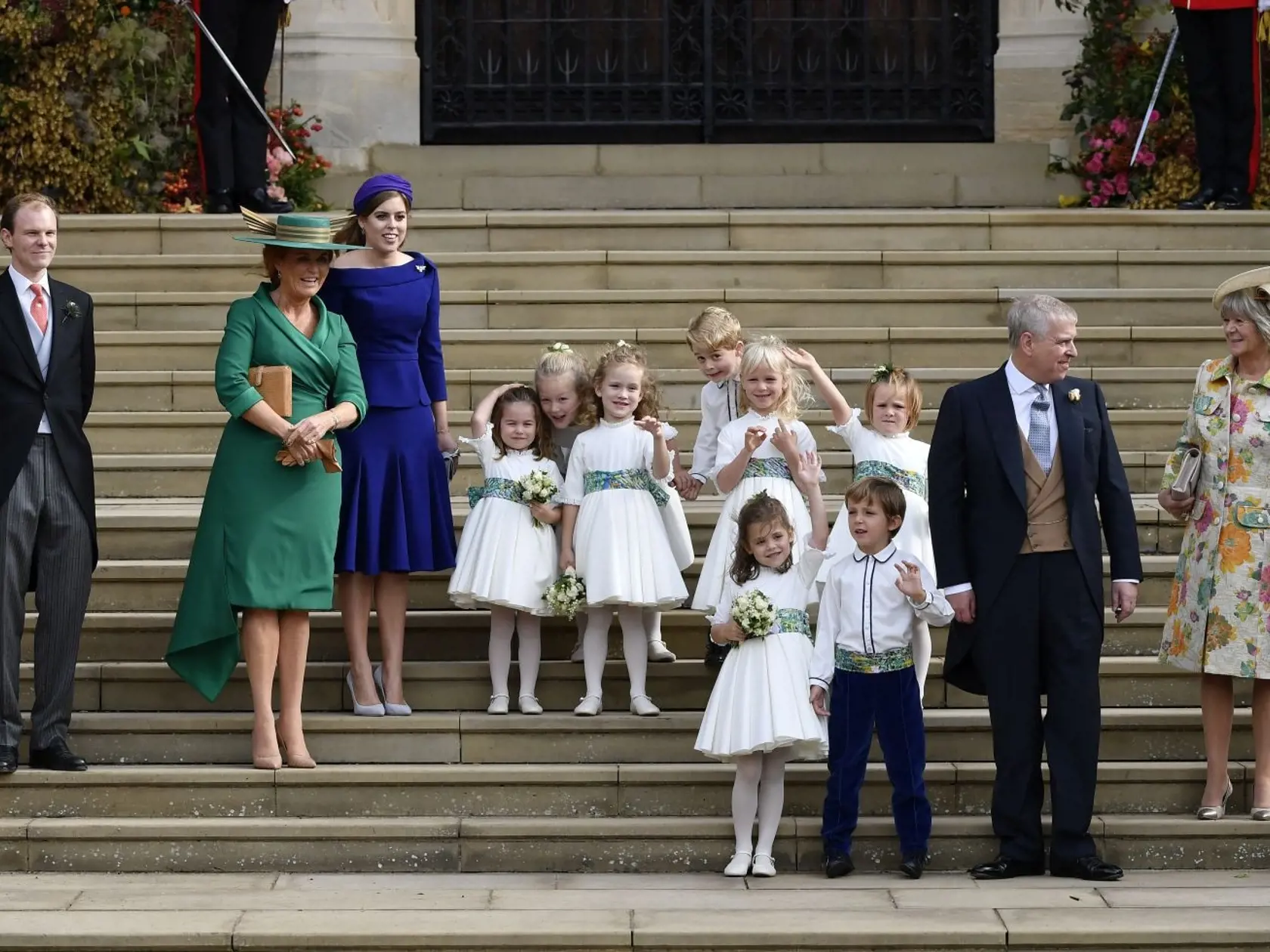 Sarah Ferguson, second left, Princess Beatrice, third left, Prince Andrew, second right, bridesmaids and page boys, including Prince George, center, and Princess Charlotte, center left, after the wedding ceremony of Princess Eugenie of York and Jack Brooksbank at St Georgeâs Chapel, Windsor Castle, near London, England, Friday Oct. 12, 2018. (Toby Melville, Pool via AP)